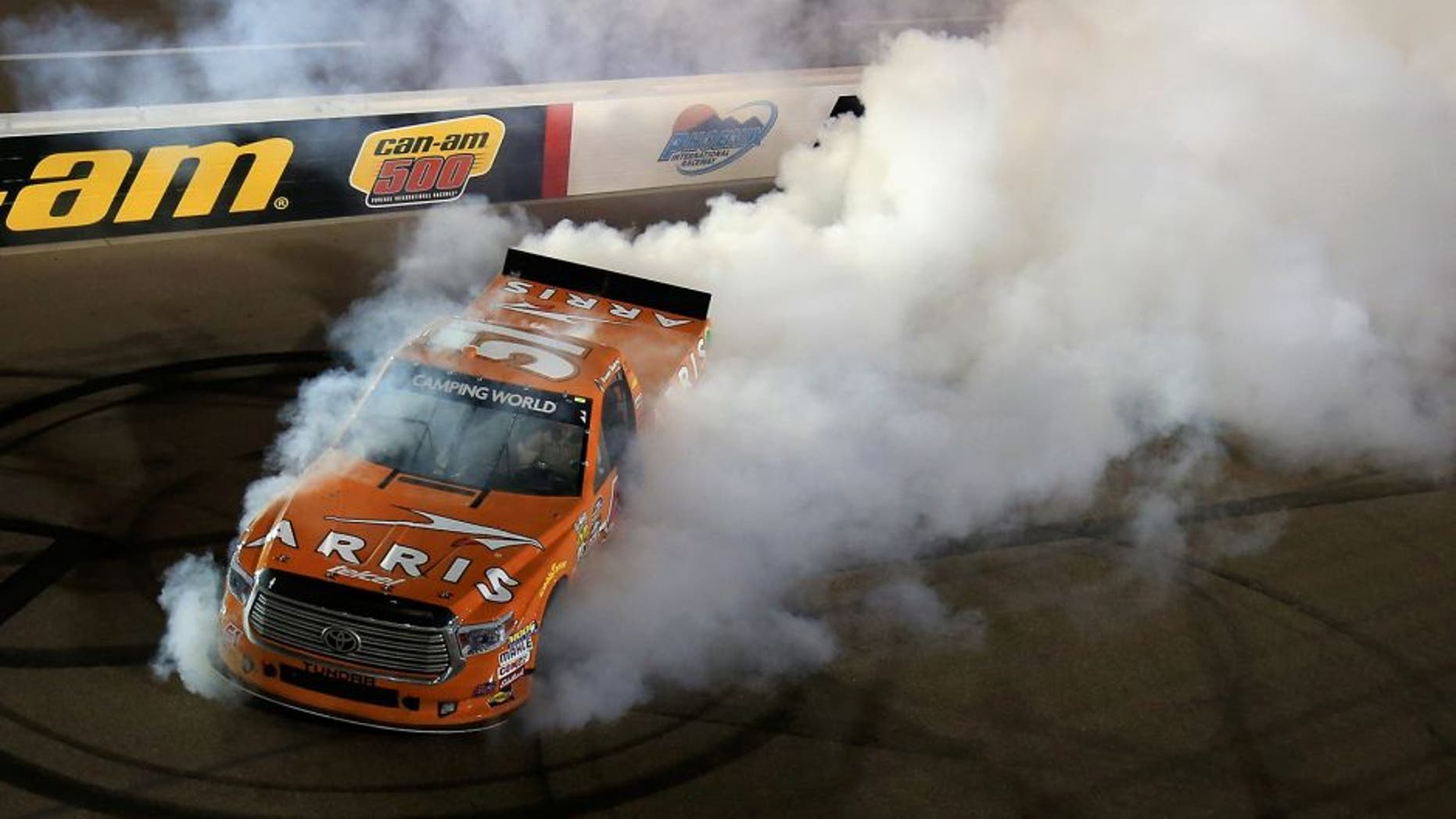 AVONDALE, AZ - NOVEMBER 11: Daniel Suarez, driver of the #51 ARRIS Toyota, celebrates with a burnout after winning the NASCAR Camping World Truck Series Lucas Oil 150 at Phoenix International Raceway on November 11, 2016 in Avondale, Arizona. (Photo by Chris Trotman/NASCAR via Getty Images)