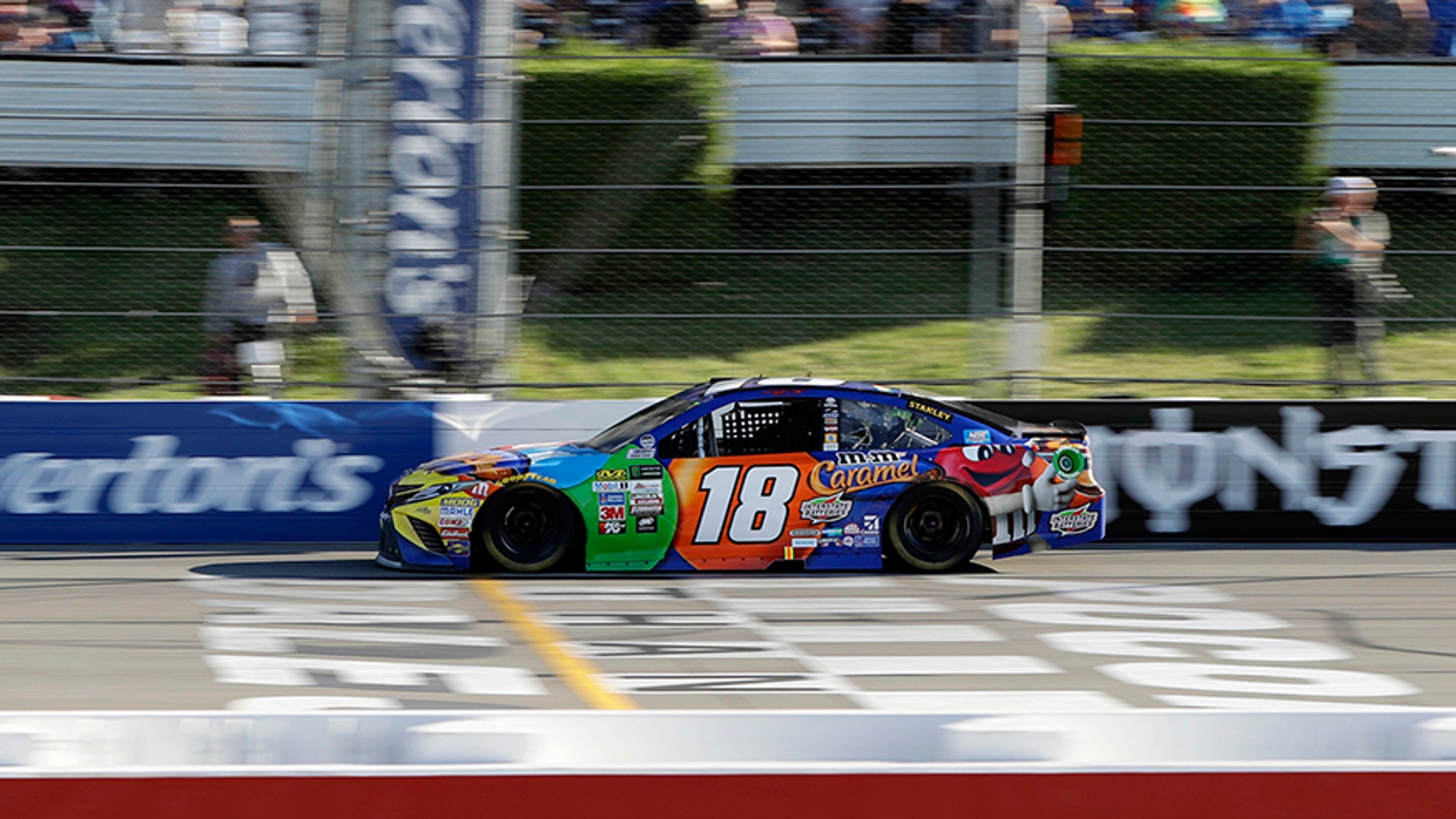 Kyle Busch crosses the finish line to win the NASCAR Cup Series auto race at Pocono Raceway, Sunday, July 30, 2017, in Long Pond, Pa. (AP Photo/Matt Slocum)