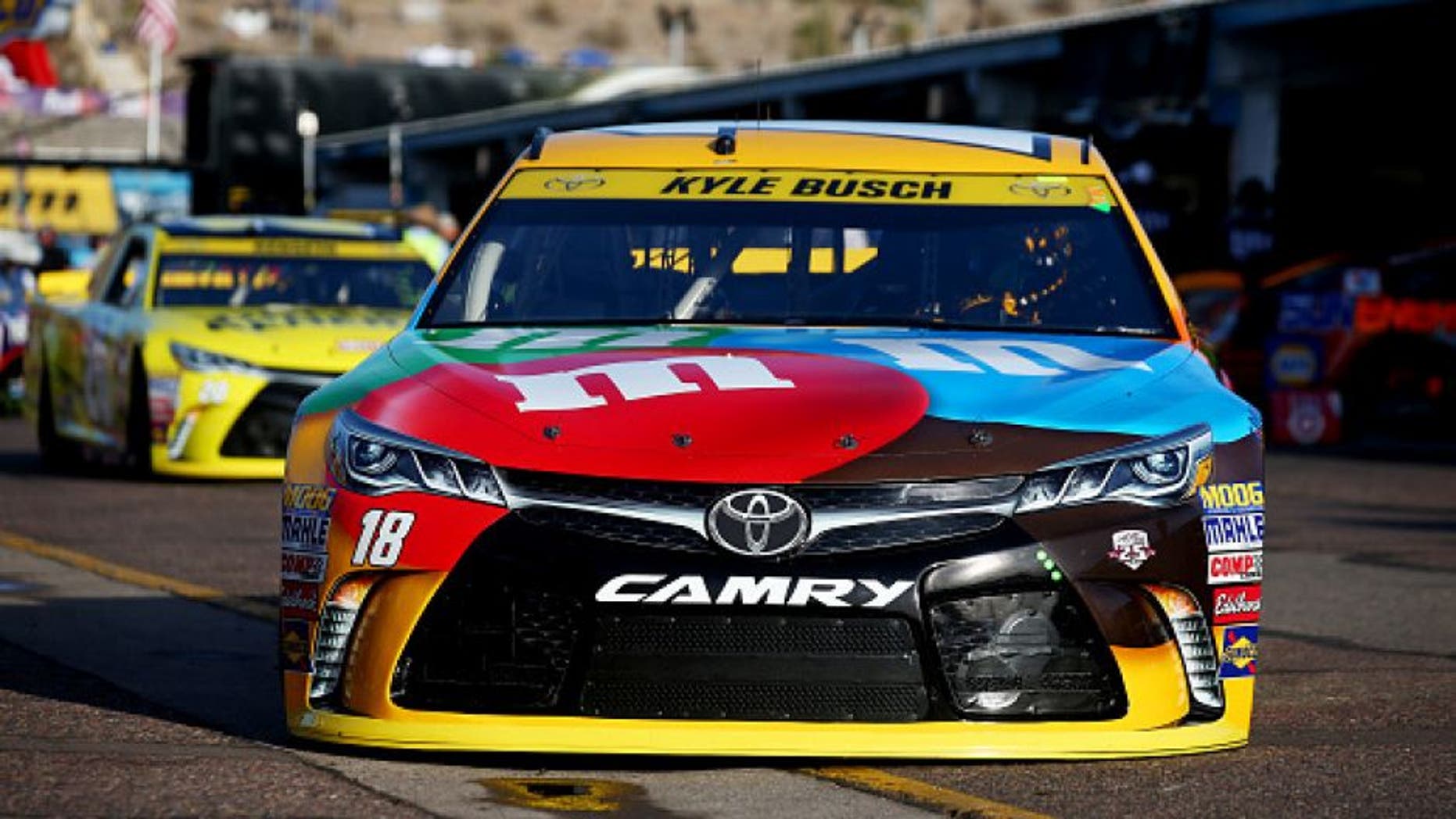 AVONDALE, AZ - NOVEMBER 12: Kyle Busch, driver of the #18 M&M's Toyota, drives through the garage area during practice for the NASCAR Sprint Cup Series Can-Am 500 at Phoenix International Raceway on November 12, 2016 in Avondale, Arizona. (Photo by Sarah Crabill/Getty Images)