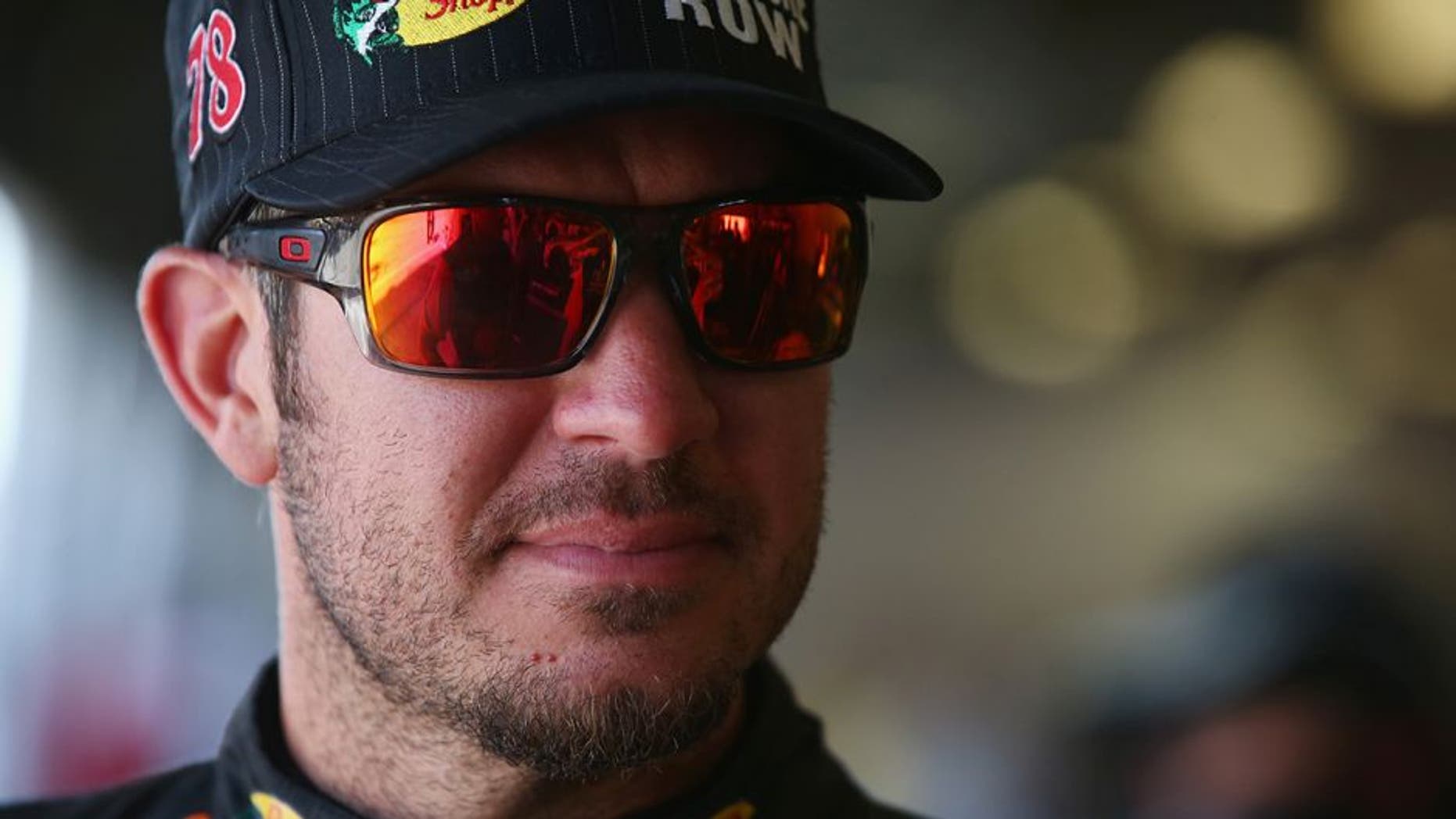 DAYTONA BEACH, FL - JULY 01: Martin Truex Jr., driver of the #78 Bass Pro Shops/Tracker Boats Toyota, stands in the garage area during practice for the NASCAR Sprint Cup Series Coke Zero 400 at Daytona International Speedway on July 1, 2016 in Daytona Beach, Florida. (Photo by Sarah Crabill/NASCAR via Getty Images)