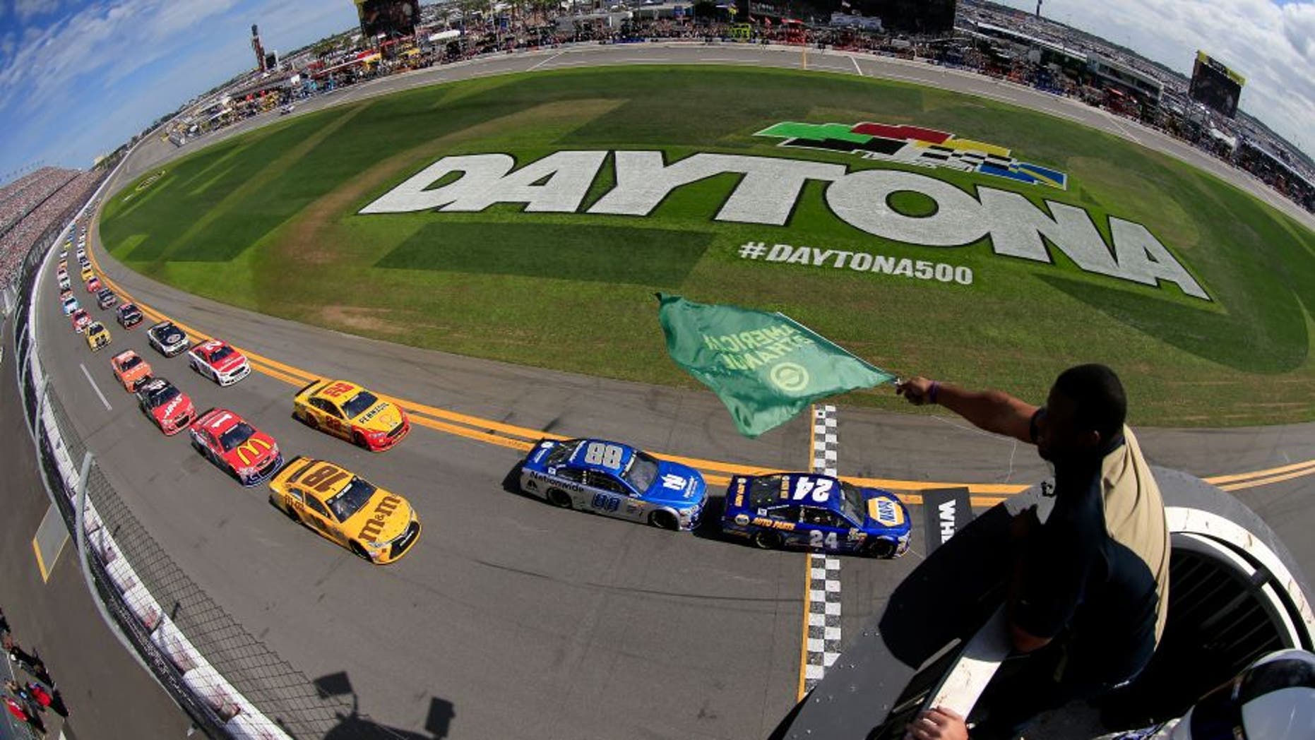 DAYTONA BEACH, FL - FEBRUARY 21: Ken Griffey Jr waves the green flag as Chase Elliott, driver of the #24 NAPA Auto Parts Chevrolet, leads the field to start the NASCAR Sprint Cup Series DAYTONA 500 at Daytona International Speedway on February 21, 2016 in Daytona Beach, Florida. (Photo by Chris Trotman/NASCAR via Getty Images)