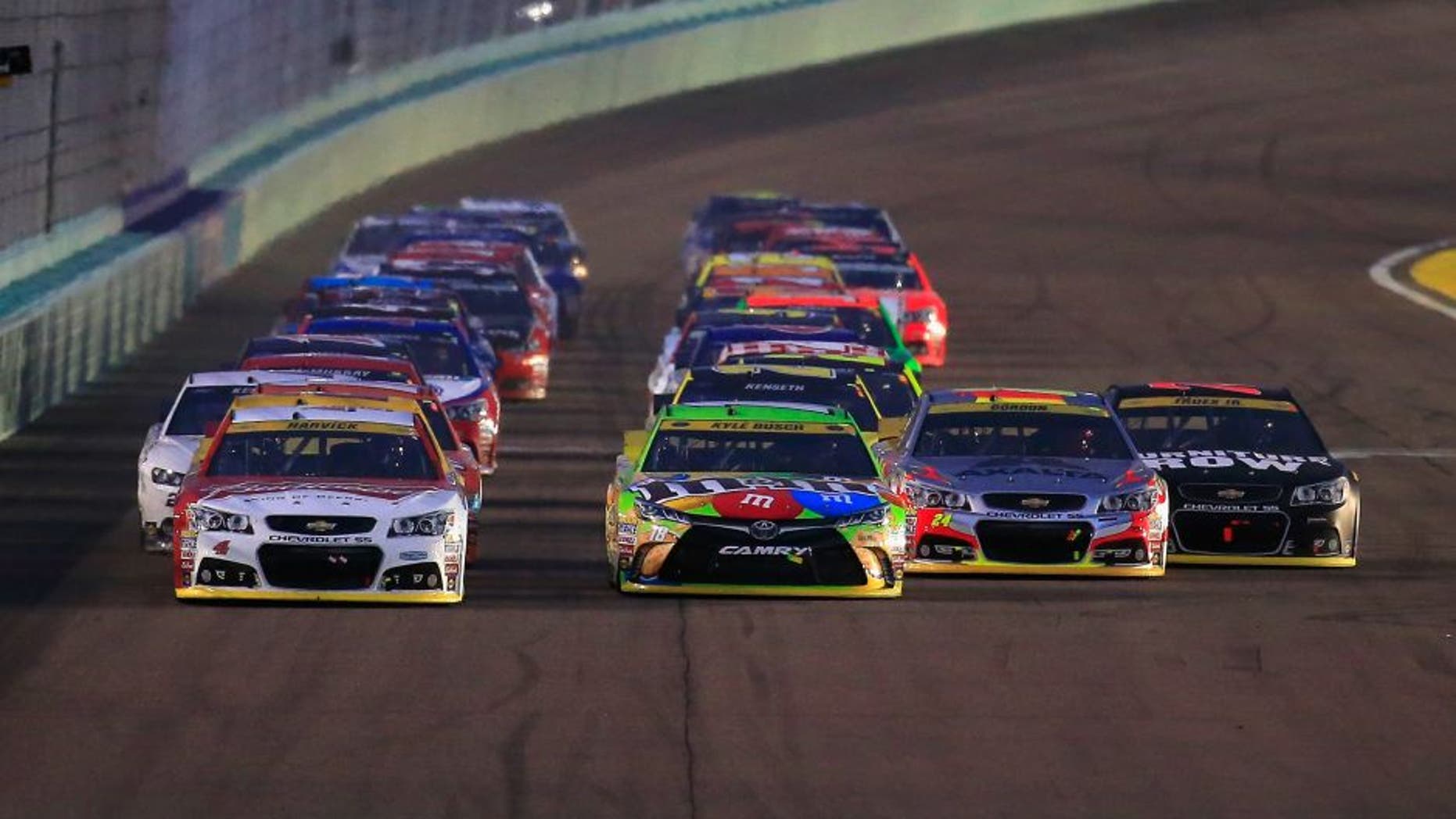 HOMESTEAD, FL - NOVEMBER 22: Kevin Harvick, driver of the #4 Budweiser/Jimmy John's Chevrolet, Kyle Busch, driver of the #18 M&M's Crispy Toyota, Jeff Gordon, driver of the #24 AXALTA Chevrolet, and Martin Truex Jr., driver of the #78 Furniture Row/Denver Mattress Chevrolet, lead the field during a restart during the NASCAR Sprint Cup Series Ford EcoBoost 400 at Homestead-Miami Speedway on November 22, 2015 in Homestead, Florida. (Photo by Chris Trotman/NASCAR via Getty Images)