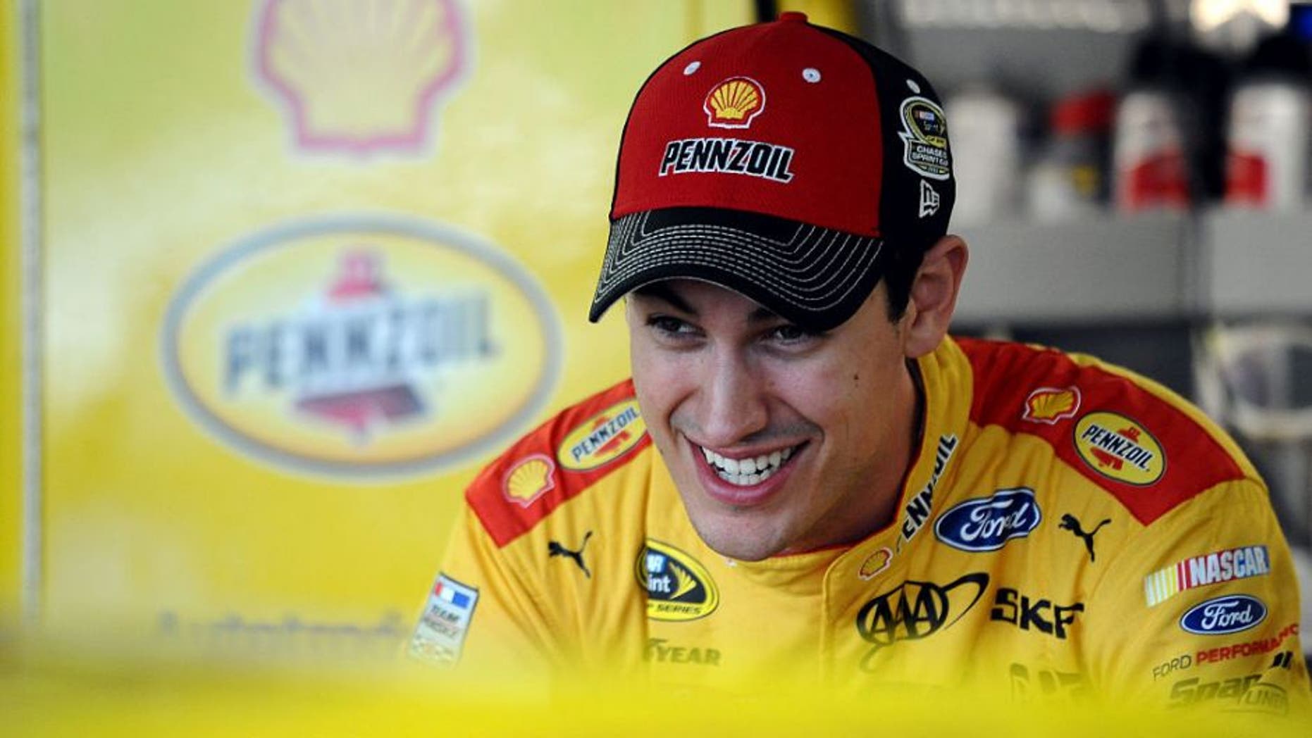 KANSAS CITY, KS - OCTOBER 14: Joey Logano, driver of the #22 Shell Pennzoil Ford, stands in the garage area during practice for the NASCAR Sprint Cup Series Hollywood Casino 400 at Kansas Speedway on October 14, 2016 in Kansas City, Kansas. (Photo by Rainier Ehrhardt/NASCAR via Getty Images)