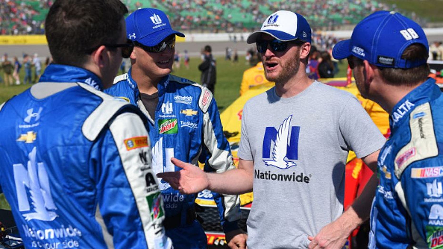 KANSAS CITY, KS - OCTOBER 16: Alex Bowman, driver of the #88 Nationwide Chevrolet, interacts with injured driver Dale Earnhardt Jr. on the grid prior to the NASCAR Sprint Cup Series Hollywood Casino 400 at Kansas Speedway on October 16, 2016 in Kansas City, Kansas. (Photo by Jason Hanna/Getty Images)