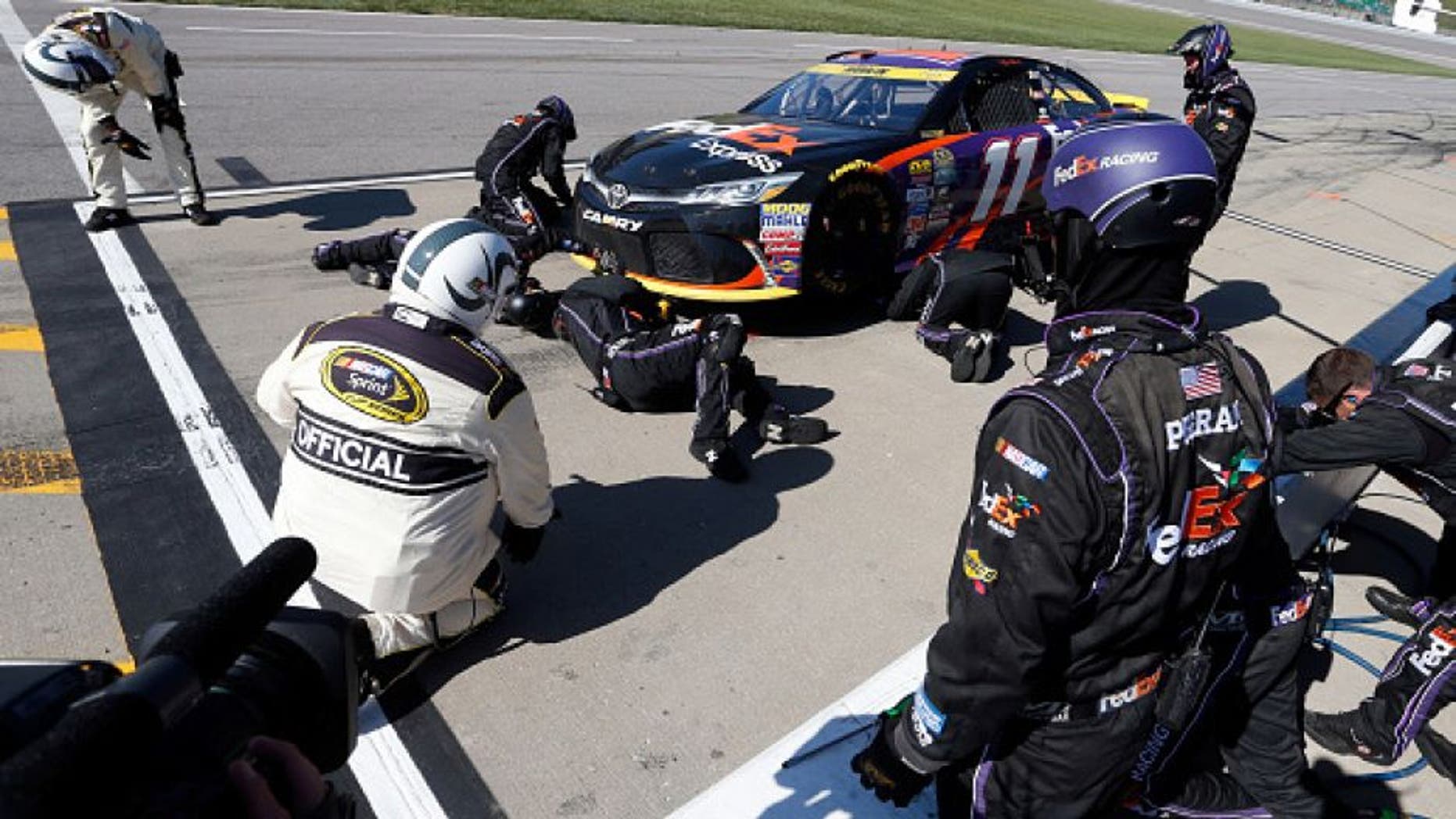 KANSAS CITY, KS - OCTOBER 16: Denny Hamlin, driver of the #11 FedEx Express Toyota, pits during the NASCAR Sprint Cup Series Hollywood Casino 400 at Kansas Speedway on October 16, 2016 in Kansas City, Kansas. (Photo by Brian Lawdermilk/NASCAR via Getty Images)