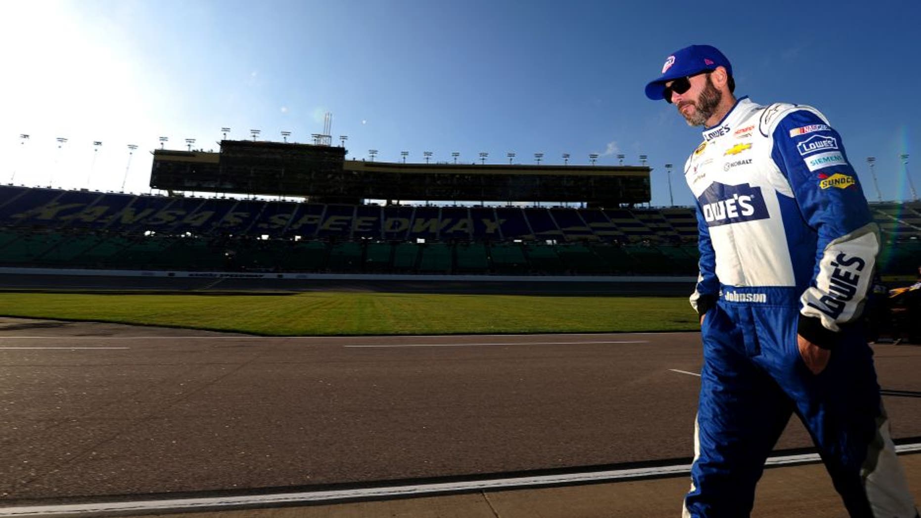KANSAS CITY, KS - OCTOBER 14: Jimmie Johnson, driver of the #48 Lowe's Chevrolet, walks on the grid prior to qualifying for the NASCAR Sprint Cup Series Hollywood Casino 400 at Kansas Speedway on October 14, 2016 in Kansas City, Kansas. (Photo by Jeff Curry/Getty Images)