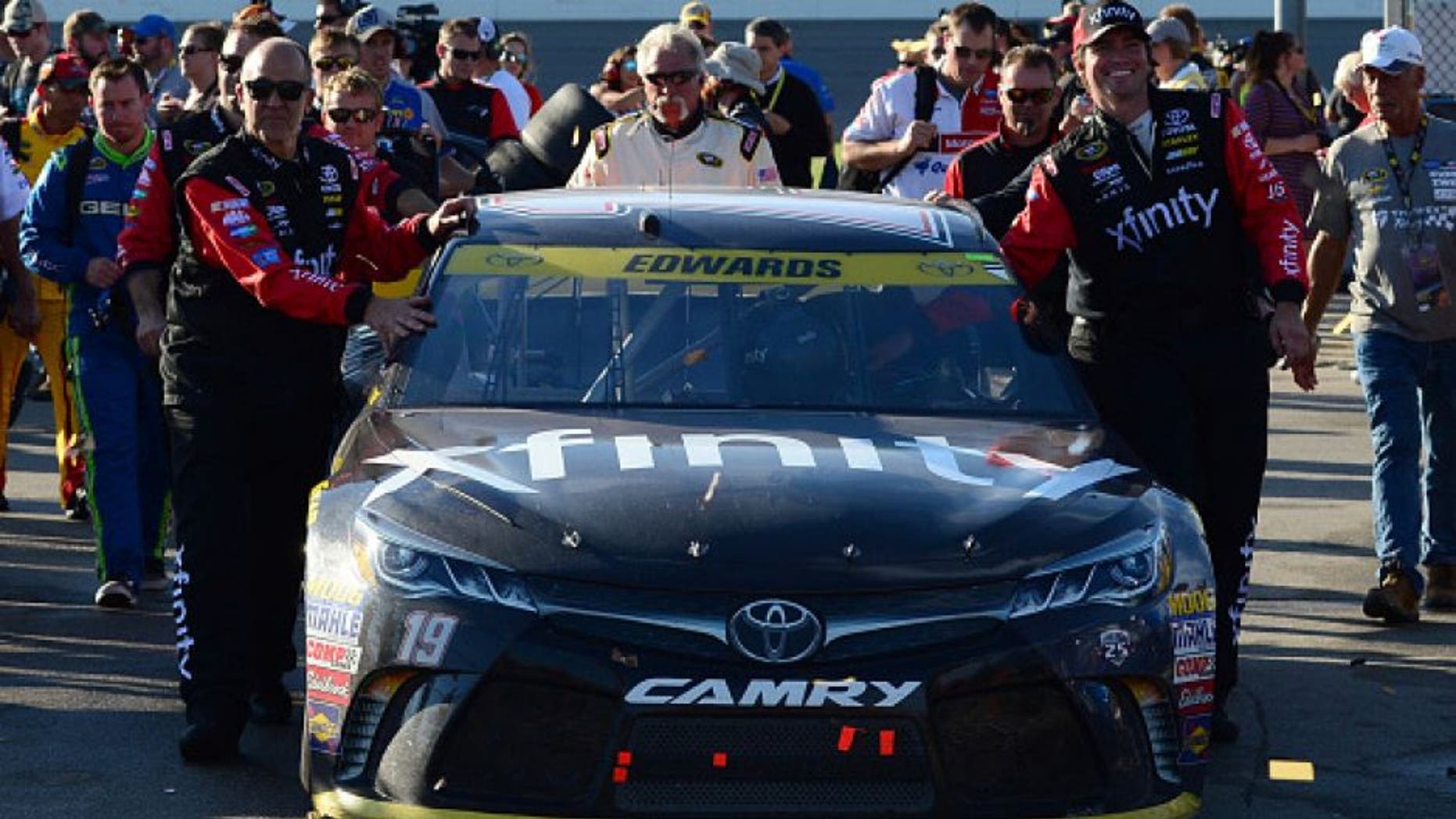 KANSAS CITY, KS - OCTOBER 16: Crew members push the #19 Xfinity Toyota through the garage area after the NASCAR Sprint Cup Series Hollywood Casino 400 at Kansas Speedway on October 16, 2016 in Kansas City, Kansas. (Photo by Jeff Curry/Getty Images)