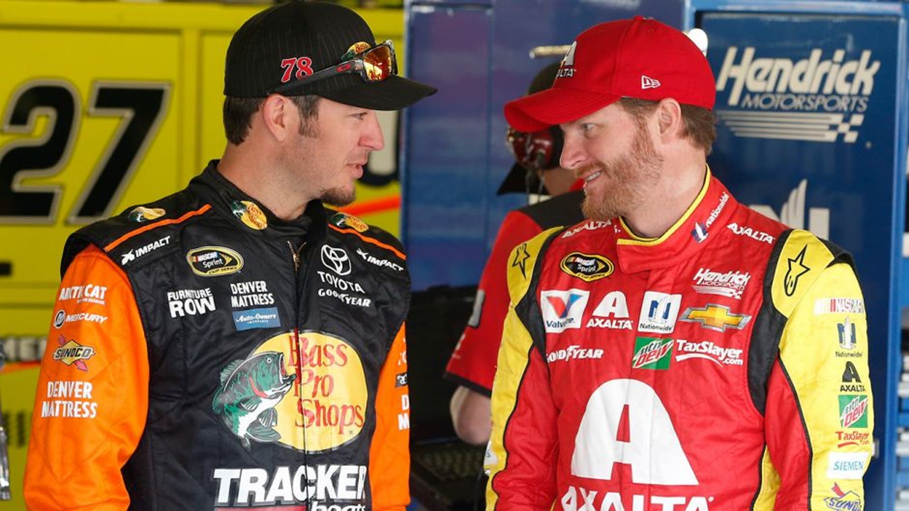 KANSAS CITY, KS - MAY 06: Martin Truex Jr., driver of the #78 Bass Pro Shops/TRACKER Boats Toyota Toyota, talks with Dale Earnhardt Jr., driver of the #88 Axalta Chevrolet, before practice for the NASCAR Sprint Cup Series Go Bowling 400 at Kansas Speedway on May 6, 2016 in Kansas City, Kansas. (Photo by Brian Lawdermilk/Getty Images)