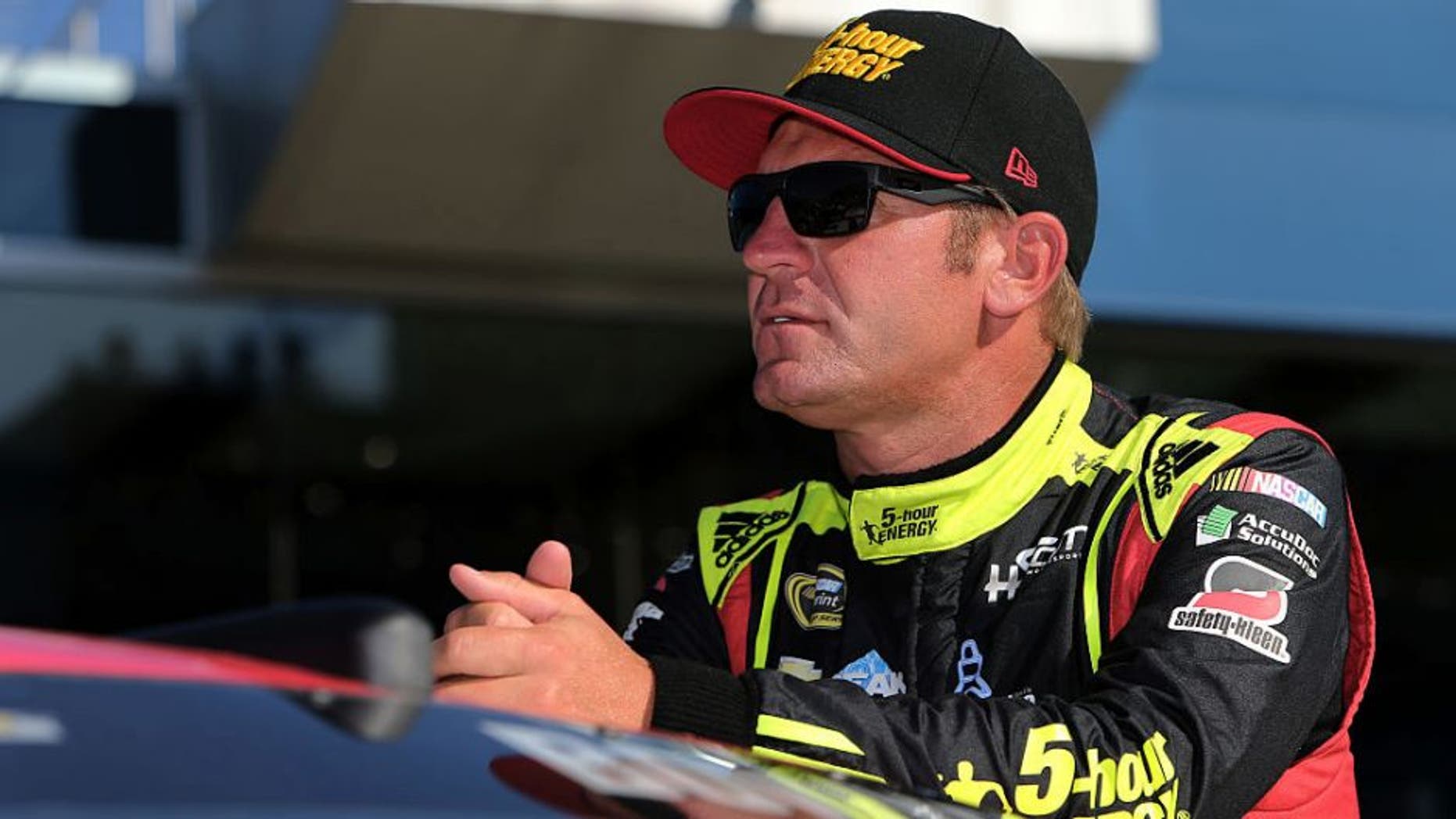 BROOKLYN, MI - AUGUST 26: Clint Bowyer, driver of the #15 5-hour Energy Chevrolet, stands on the grid during qualifying for the NASCAR Sprint Cup Series Pure Michigan 400 at Michigan International Speedway on August 26, 2016 in Brooklyn, Michigan. (Photo by Rey Del Rio/Getty Images)