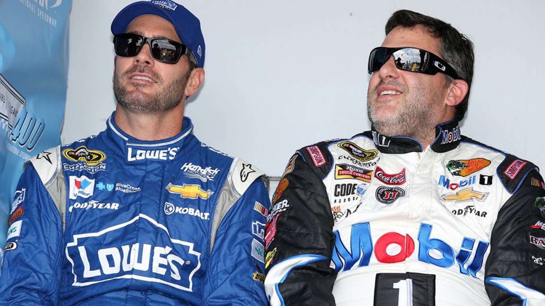 BROOKLYN, MI - AUGUST 16: (L-R) Jimmie Johnson, driver of the #48 Lowe's Chevrolet, and Tony Stewart, driver of the #14 Mobil 1/Bass Pro Shops Chevrolet, during driver introductions before the NASCAR Sprint Cup Series Pure Michigan 400 at Michigan International Speedway on August 16, 2015 in Brooklyn, Michigan. (Photo by Jerry Markland/Getty Images)