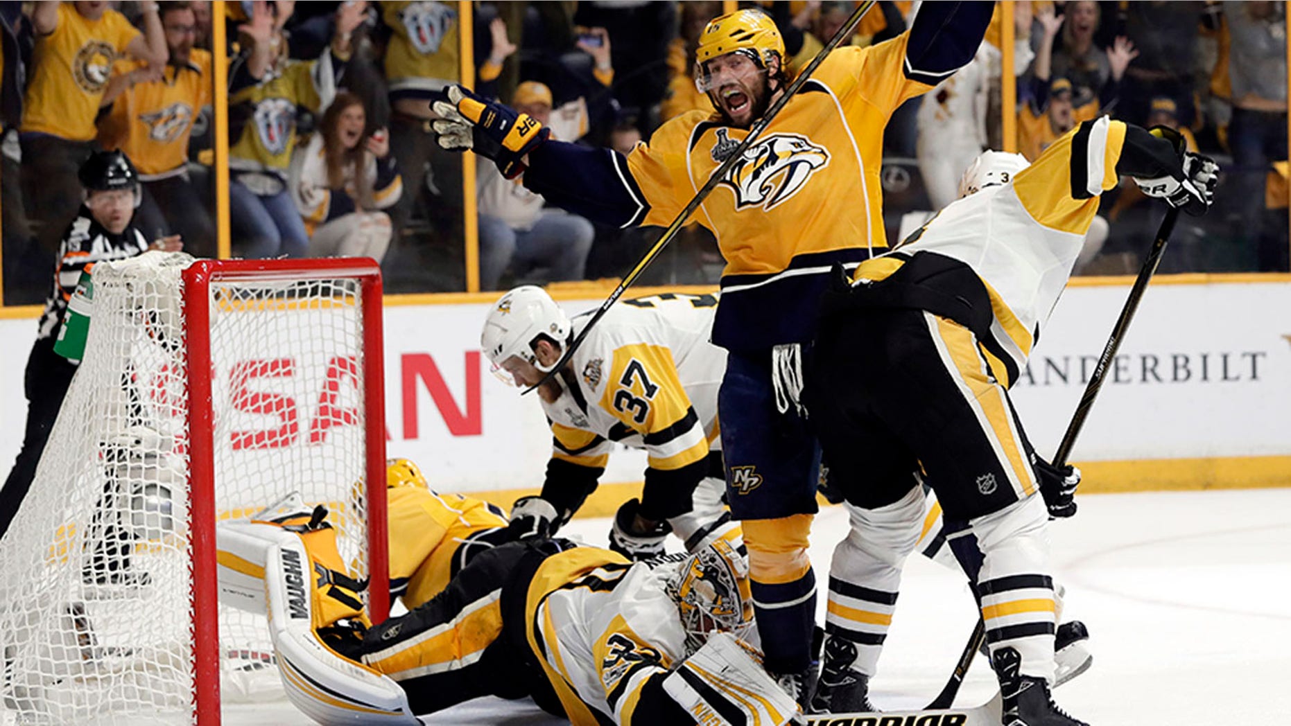 Nashville Predators right wing Craig Smith, center, celebrates a goal by teammate Calle Jarnkrok, not shown, as Pittsburgh Penguins goalie Matt Murray, bottom, falls on the ice during the first period in Game 4 of the NHL hockey Stanley Cup Finals Monday, June 5, 2017, in Nashville, Tenn. (AP Photo/Mark Humphrey)