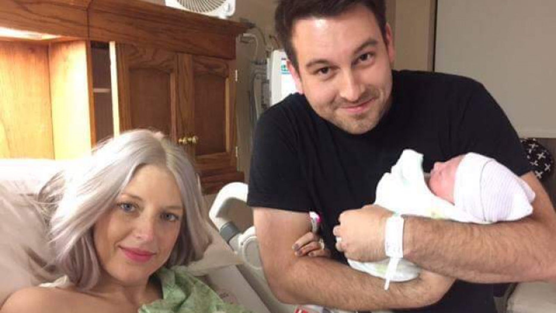 Nathan Johnson is pictured with his wife, Meg, and their newborn Eilee.