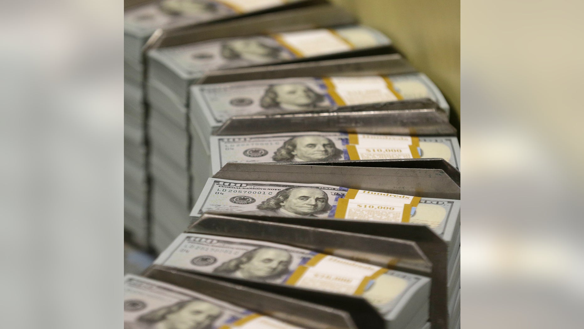 In this photo taken Sept. 24, 2013, just cut stacks of $100 bills make their way down the line at the Bureau of Engraving and Printing Western Currency Facility in Fort Worth, Texas. The nationâs health care tab is expected to surpass $10,000 per person for the first time this year, the government said Wednesday. The new peak suggests the Obama administration will pass the problem of high health care costs on to its successor. (AP Photo/LM Otero)