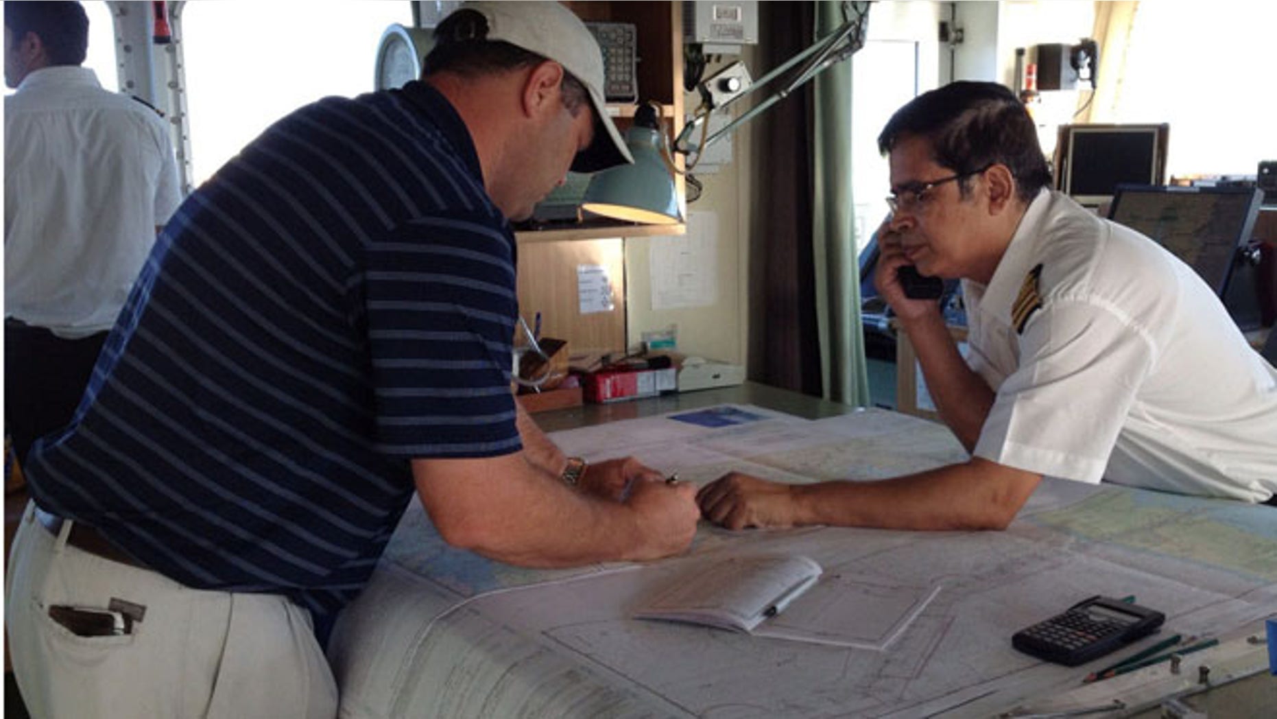 FILE: Mariners use a printed nautical chart aboard their ship. The National Oceanic and Atmospheric Administration announced on Tuesday that the traditional heavy paper lithographic nautical charts will stop being printed next April.