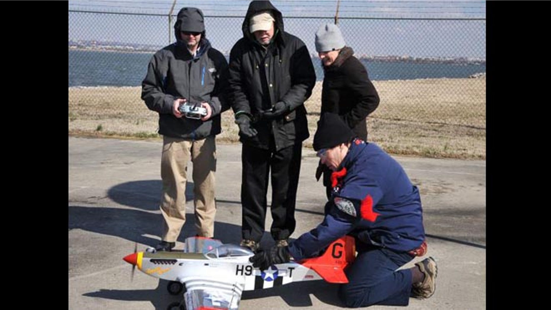 Flying a radio-controlled replica of the historic WWII P-51 Mustang red-tail aircraft—of the legendary Tuskegee Airmen—NRL researchers (left to right) Dr. Jeffrey Baldwin, Dr. Dennis Hardy, Dr. Heather Willauer, and Dr. David Drab, successfully demonstrate a novel liquid hydrocarbon fuel to power the aircraft's unmodified two-stroke internal combustion engine.
