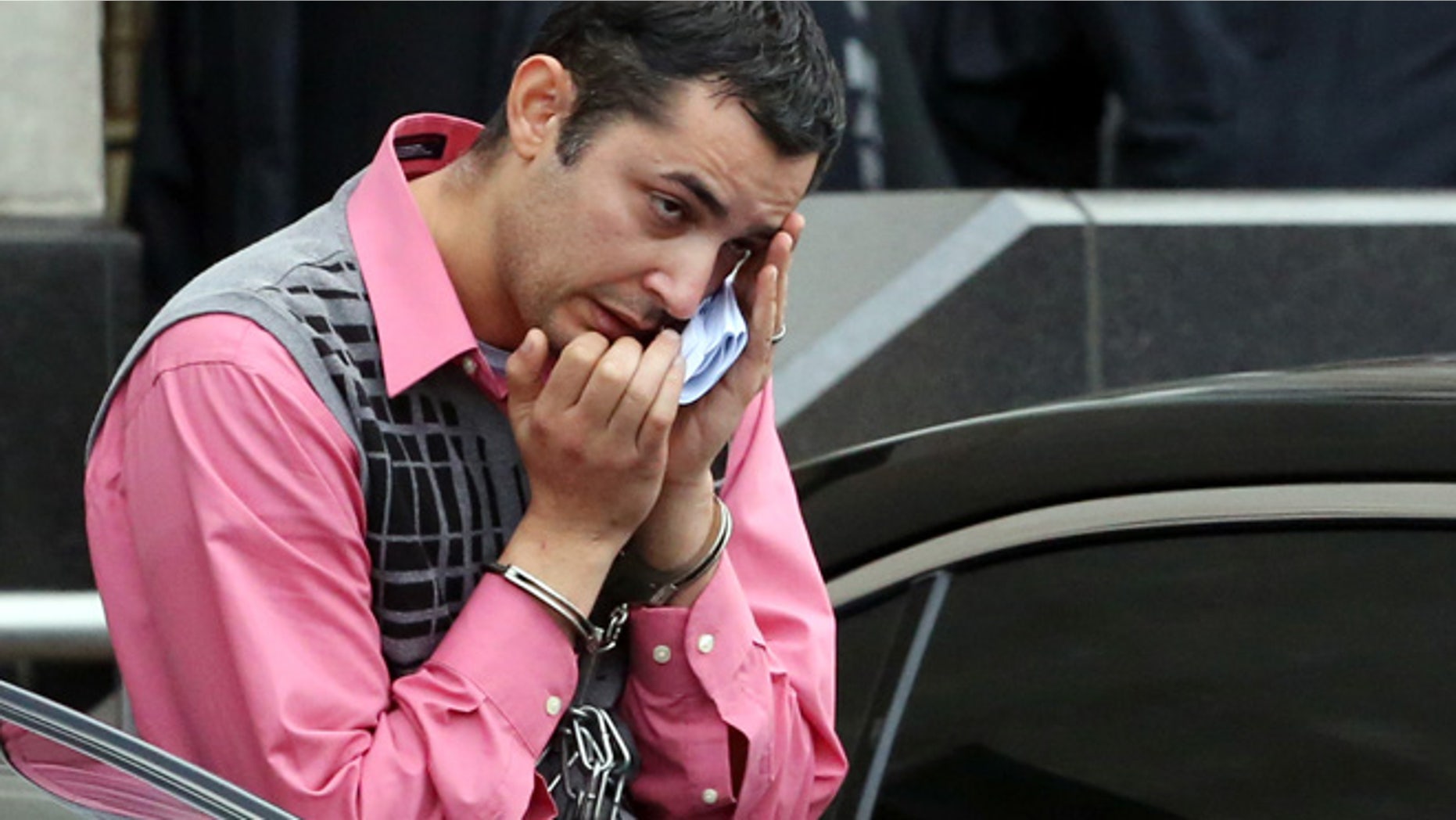 Mostafa Ahmed Awwad, 35, of Yorktown, Va., a civilian with the U.S. Navy, leaves the federal courthouse in Norfolk, Va. on Friday, Dec. 5, 2014 after he was arrested on charges he tried to steal schematics for the under construction Gerald R. Ford aircraft carrier for Egypt.