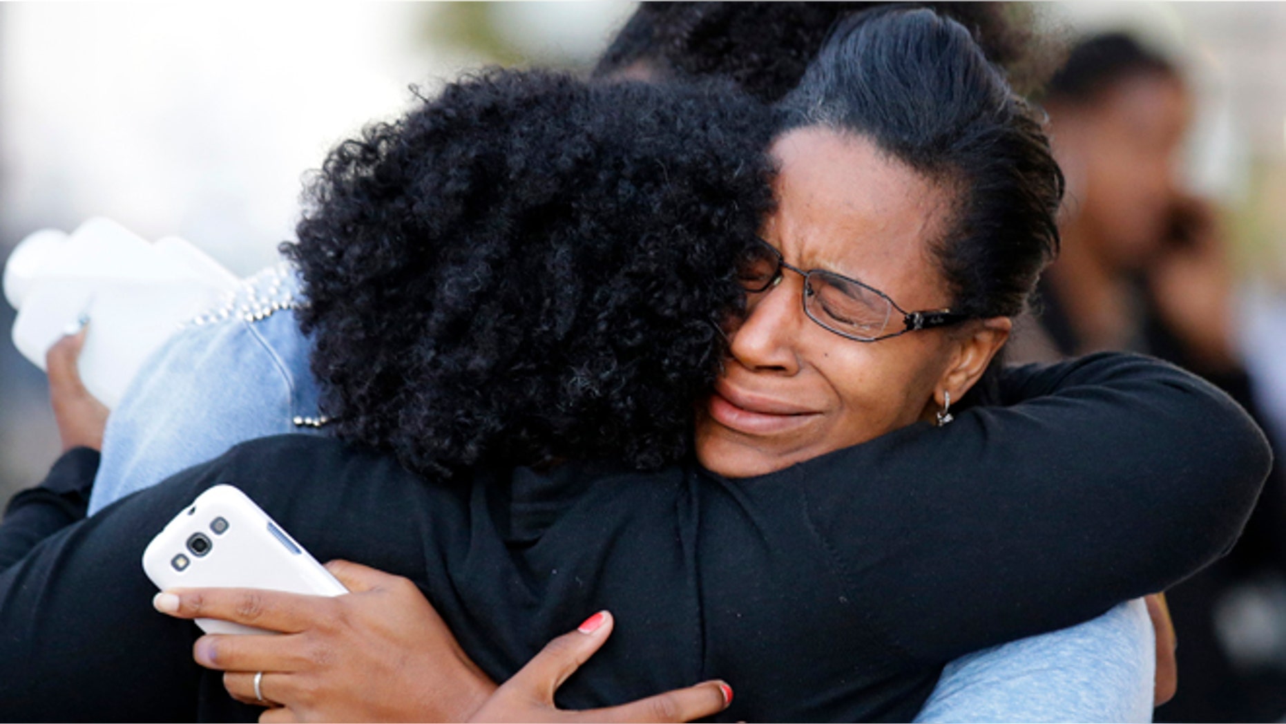 Sept. 16, 2013: Three women embrace near Nationals Park where family members waited to greet loved ones that were at the Washington Navy Yard in Washington. At least one gunman launched an attack inside the Washington Navy Yard, spraying gunfire on office workers in the cafeteria and in the hallways at the heavily secured military installation in the heart of the nation's capital, authorities said. (AP/Alex Brandon)