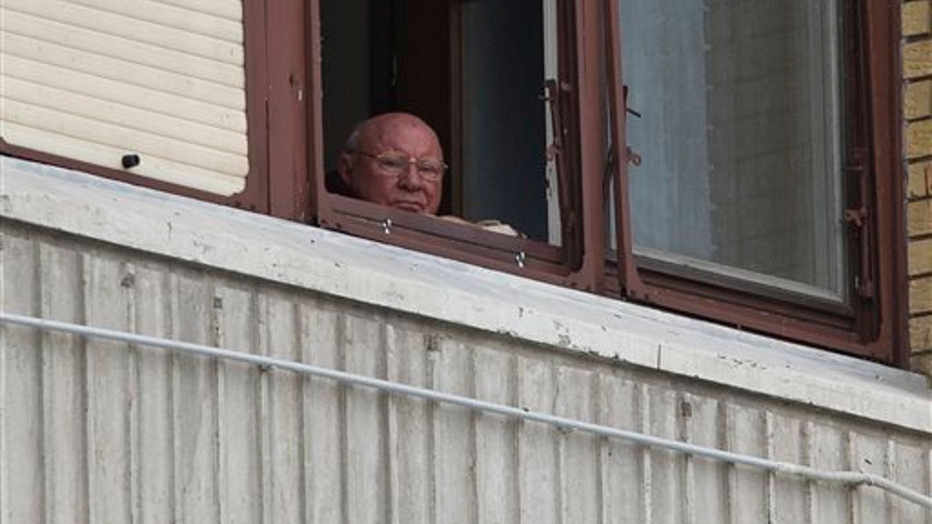 July 28, 2014: Jakob Denzinger looks from his apartment window in Osijek, eastern Croatia.