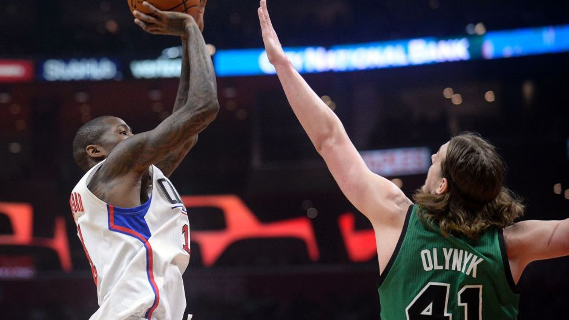 March 6, 2017; Los Angeles, CA, USA; Los Angeles Clippers guard Jamal Crawford (11) shoots against the defense of Boston Celtics center Kelly Olynyk (41) during the first half at Staples Center. Mandatory Credit: Gary A. Vasquez-USA TODAY Sports