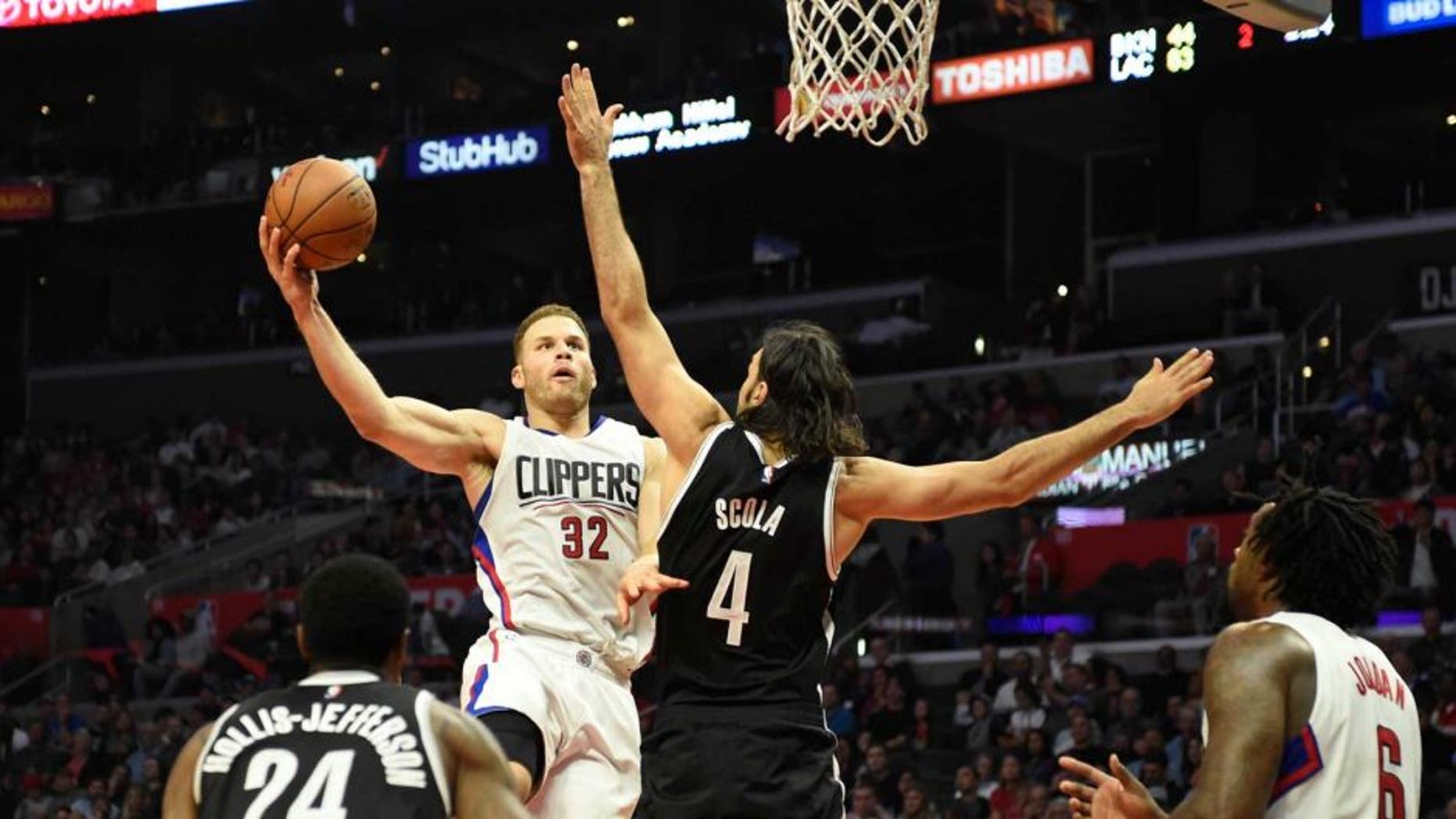 Nov 14, 2016; Los Angeles, CA, USA; Los Angeles Clippers forward Blake Griffin (32) shoots against Brooklyn Nets forward Luis Scola (4) in the first half of a NBA basketball game at Staples Center. Mandatory Credit: Richard Mackson-USA TODAY Sports