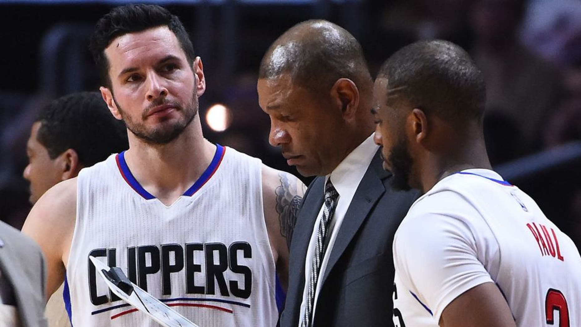Feb 26, 2017; Los Angeles, CA, USA; Los Angeles Clippers head coach Doc Rivers talks with guard J.J. Redick (4) and guard Chris Paul (3) during a time out in the second half of the game against the Charlotte Hornets at Staples Center. Clippers won in OT 124-121. Mandatory Credit: Jayne Kamin-Oncea-USA TODAY Sports