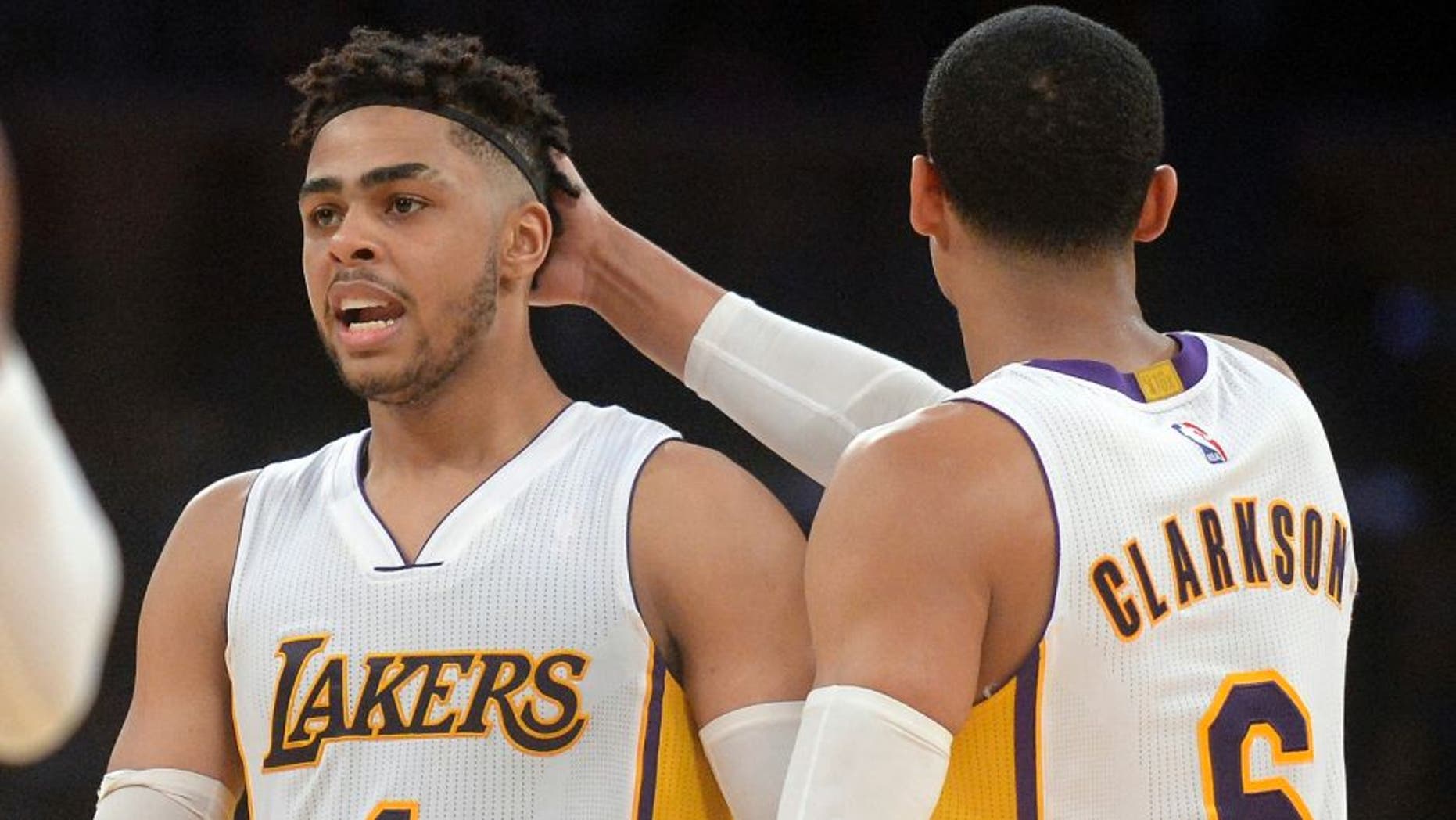 March 19, 2017; Los Angeles, CA, USA; Los Angeles Lakers guard D'Angelo Russell (1) reacts with guard Jordan Clarkson (6) after drawing a foul against the Cleveland Cavaliers during second half at Staples Center. Mandatory Credit: Gary A. Vasquez-USA TODAY Sports