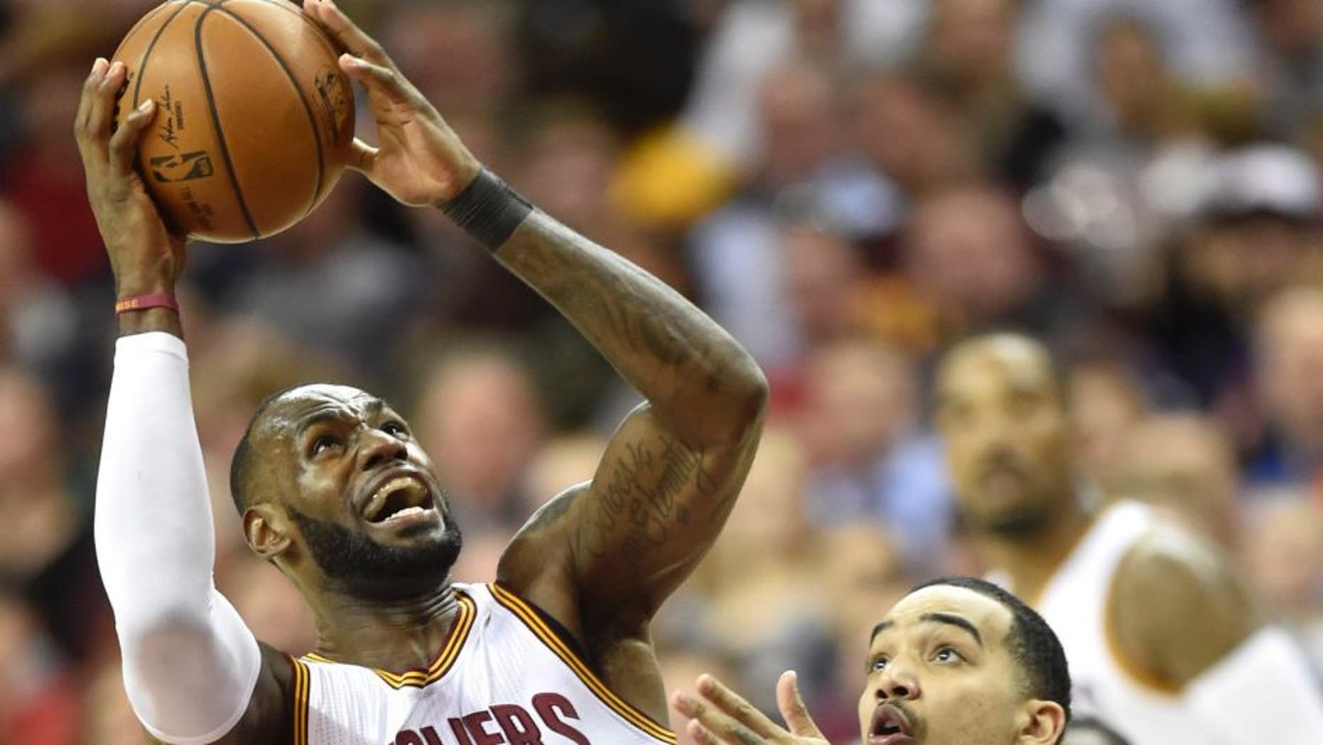 Mar 16, 2017; Cleveland, OH, USA; Cleveland Cavaliers forward LeBron James (23) shoots against Utah Jazz forward Trey Lyles (41) in the second quarter at Quicken Loans Arena. Mandatory Credit: David Richard-USA TODAY Sports