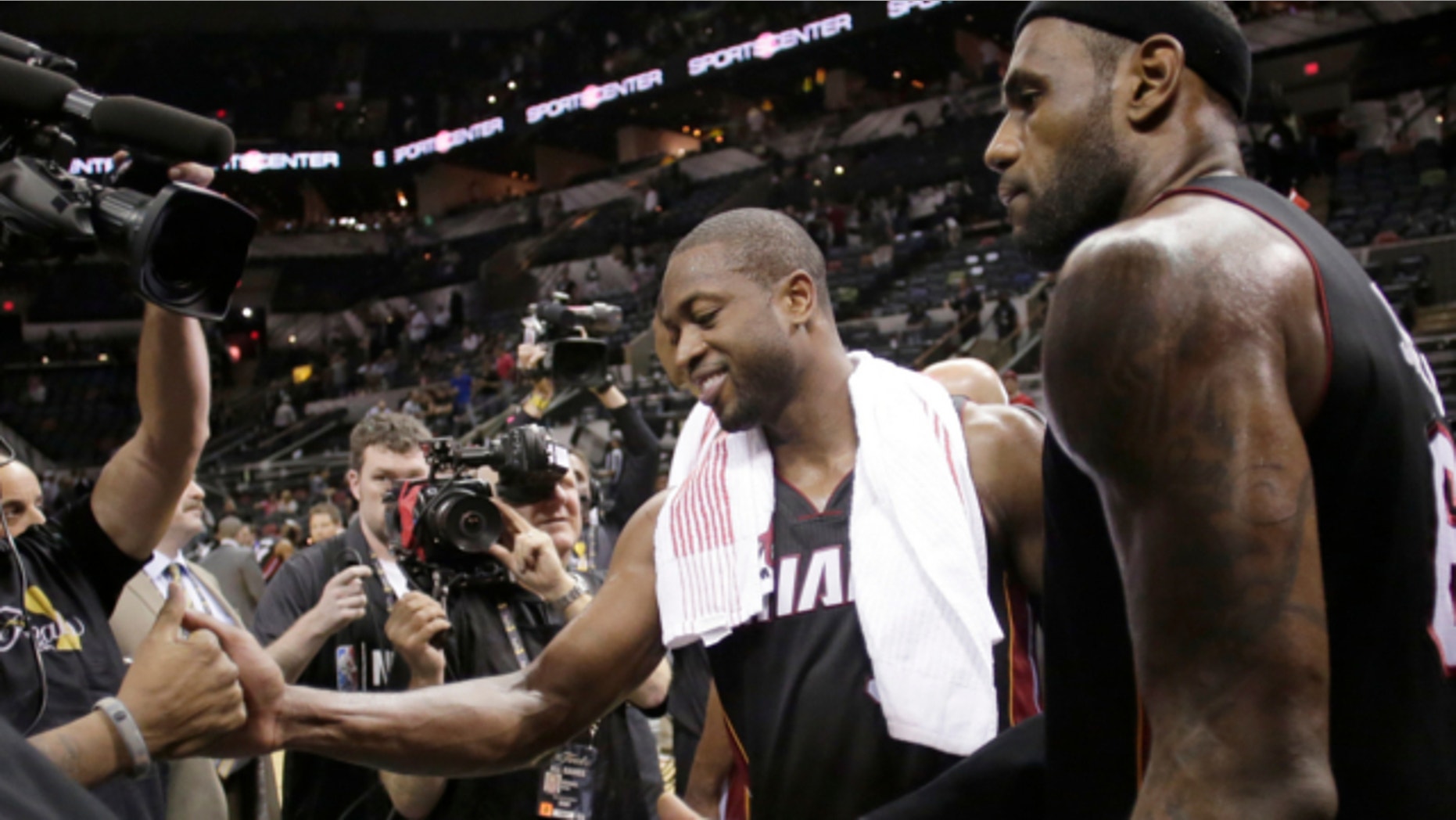 June 13, 2013: Miami Heat's Dwyane Wade, left, and LeBron James leave the floor after beating San Antonio Spurs at Game 4 of the NBA Finals basketball series in San Antonio.