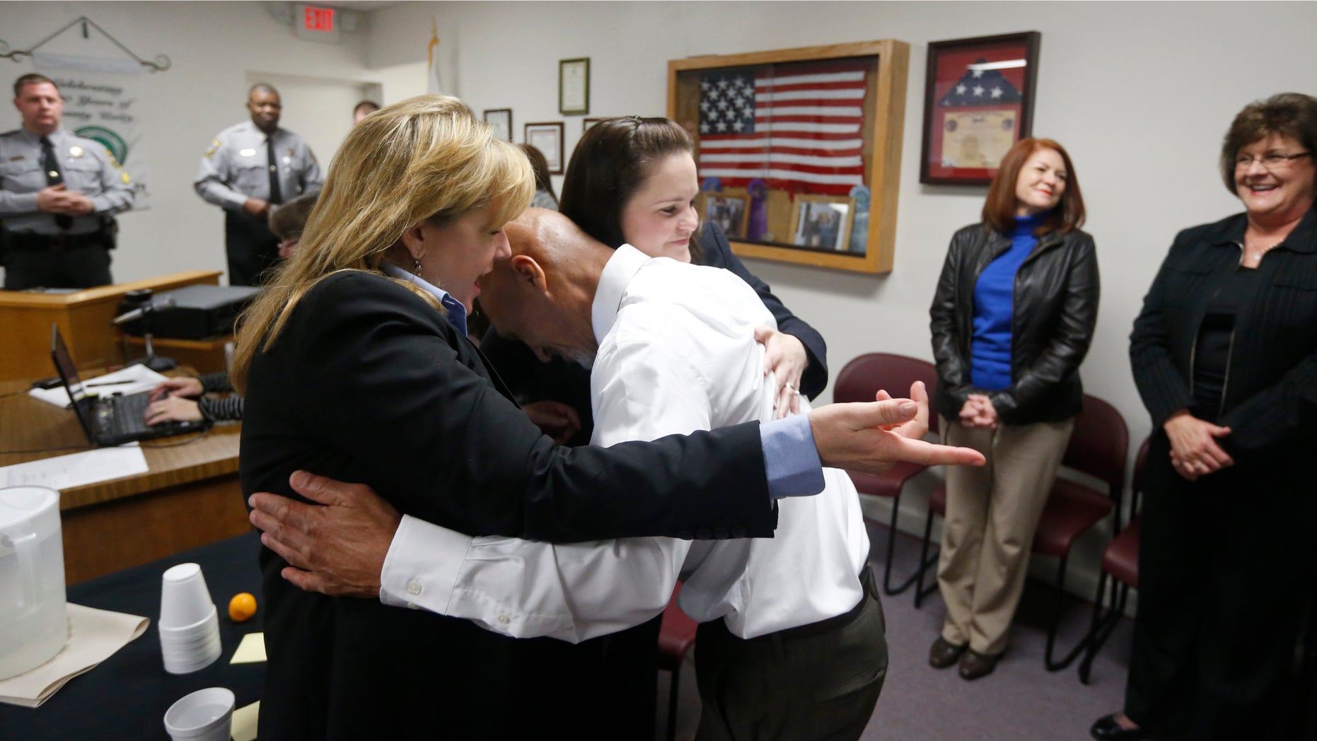 Jan. 23, 2015: Christine Mumma, director of the North Carolina Center on Actual Innocence, left, and Cheryl Sullivan, staff attorney, hug Joseph Sledge after a special session of superior court in Whiteville, N.C.