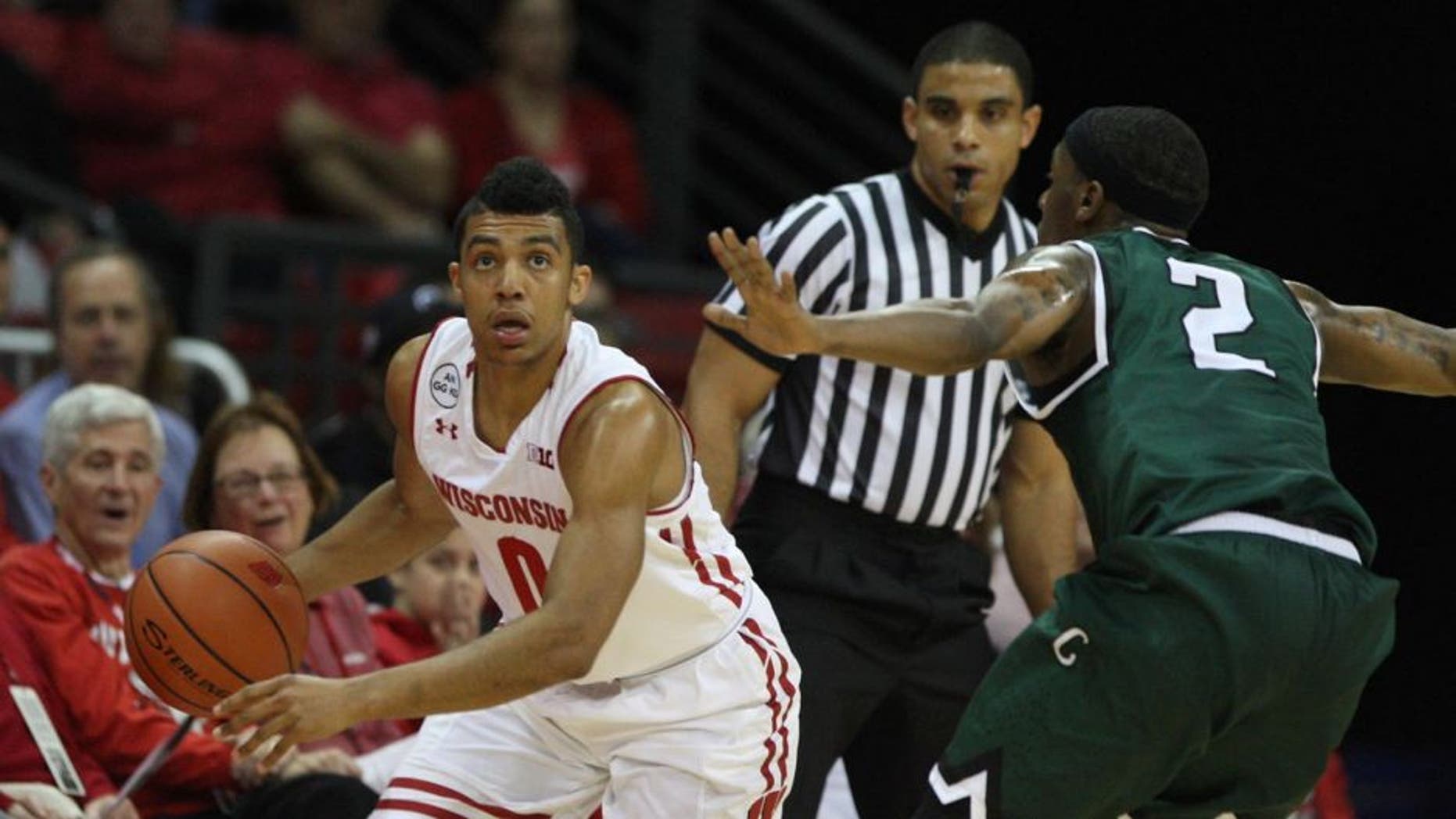 Nov 17, 2016; Madison, WI, USA; Wisconsin Badgers guard D'Mitrik Trice (0) controls the ball as Chicago State Cougars guard Clemmlye Owens V (2) defends at the Kohl Center. Mandatory Credit: Mary Langenfeld-USA TODAY Sports