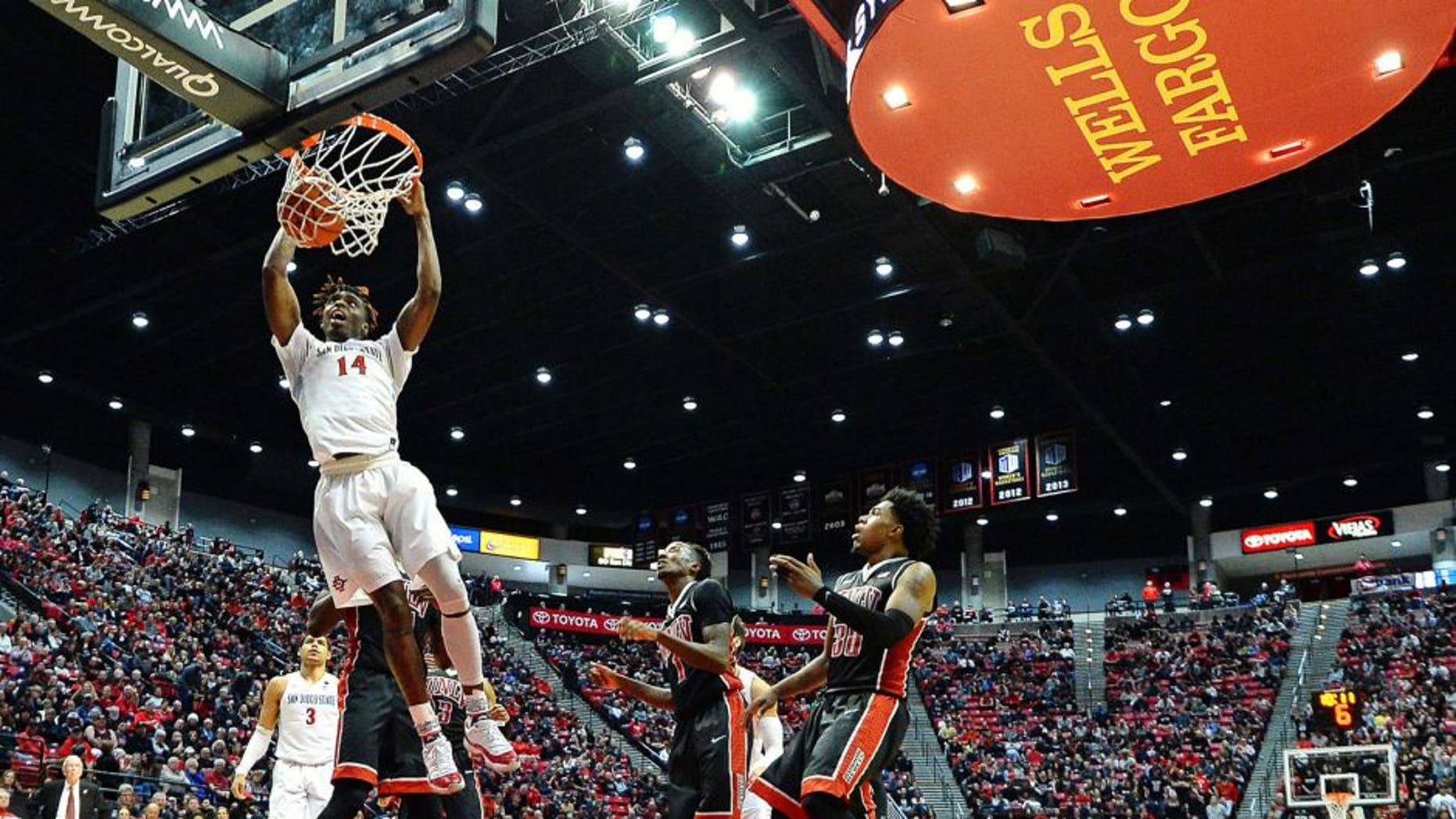 Feb 19, 2017; San Diego, CA, USA; San Diego State Aztecs forward Zylan Cheatham (14) dunks as UNLV Rebels guard Jovan Mooring (30) and guard Kris Clyburn (1) look on during the second half at Viejas Arena at Aztec Bowl. Mandatory Credit: Jake Roth-USA TODAY Sports