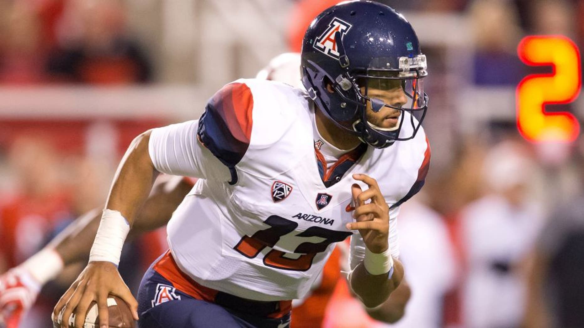 Oct 8, 2016; Salt Lake City, UT, USA; Arizona Wildcats quarterback Brandon Dawkins (13) runs with the ball during the first half against the Utah Utes at Rice-Eccles Stadium. Mandatory Credit: Russ Isabella-USA TODAY Sports