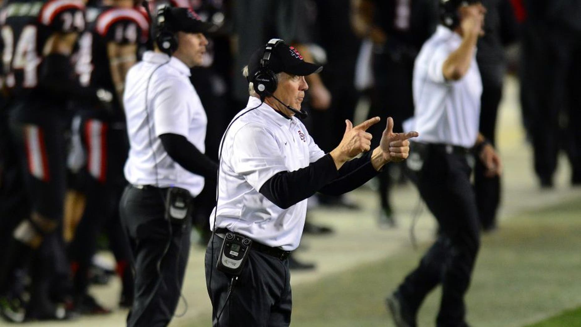 Dec 23, 2014; San Diego, CA, USA; San Diego State Aztecs head coach Rocky Long (center) gestures during the fourth quarter against the Navy Midshipmen at Qualcomm Stadium. Mandatory Credit: Jake Roth-USA TODAY Sports