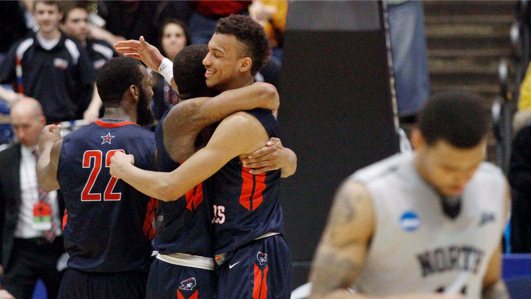 March 18, 2015: Robert Morris players celebrate after an 81-77 win over North Florida in a first round NCAA tournament basketball game.