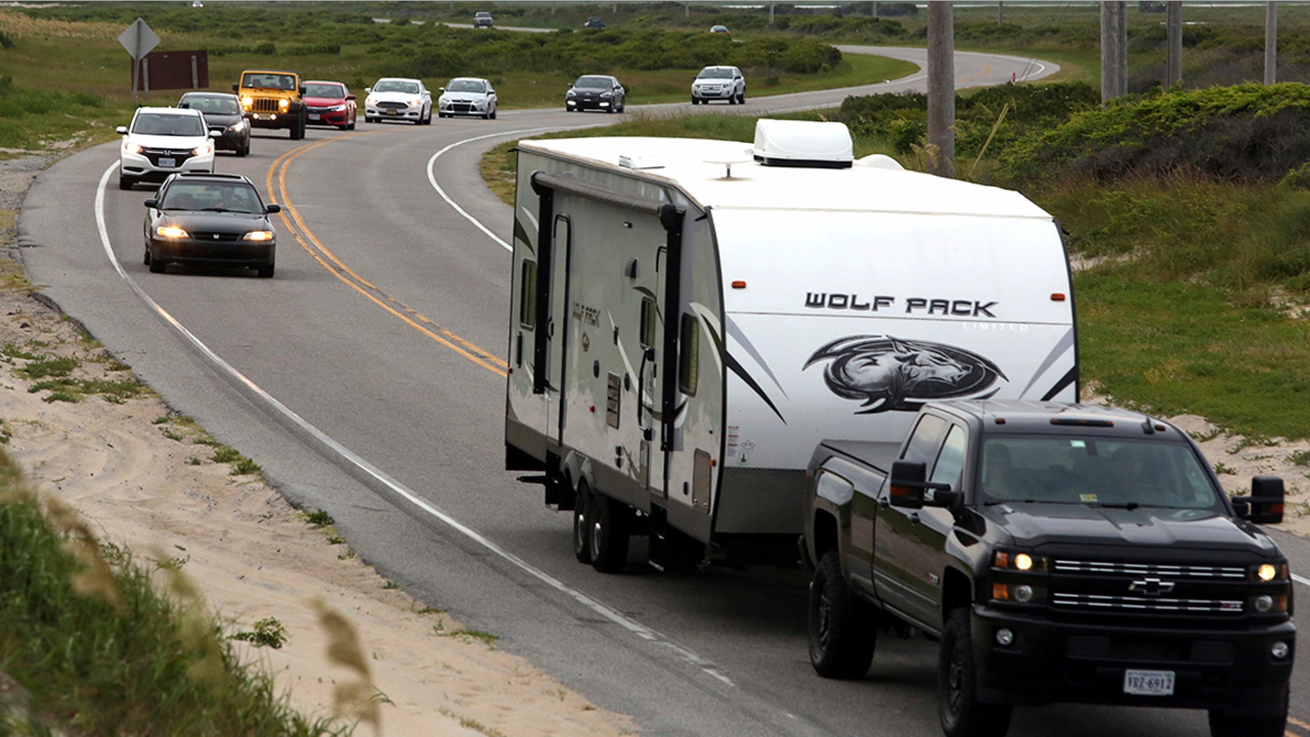 Vacationers head north on NC 12 on Hatteras Island, N.C., on Friday.