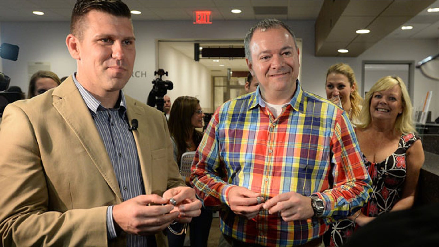 Oct. 10, 2014: Wake County Sheriffs Deputies Chad Biggs, 35, left, and Chris Creech, 46, hold their wedding rings as they say their vows before Wake County Magistrate Dexter Williams at the Wake County Courthouse in Raleigh, N.C. (AP)