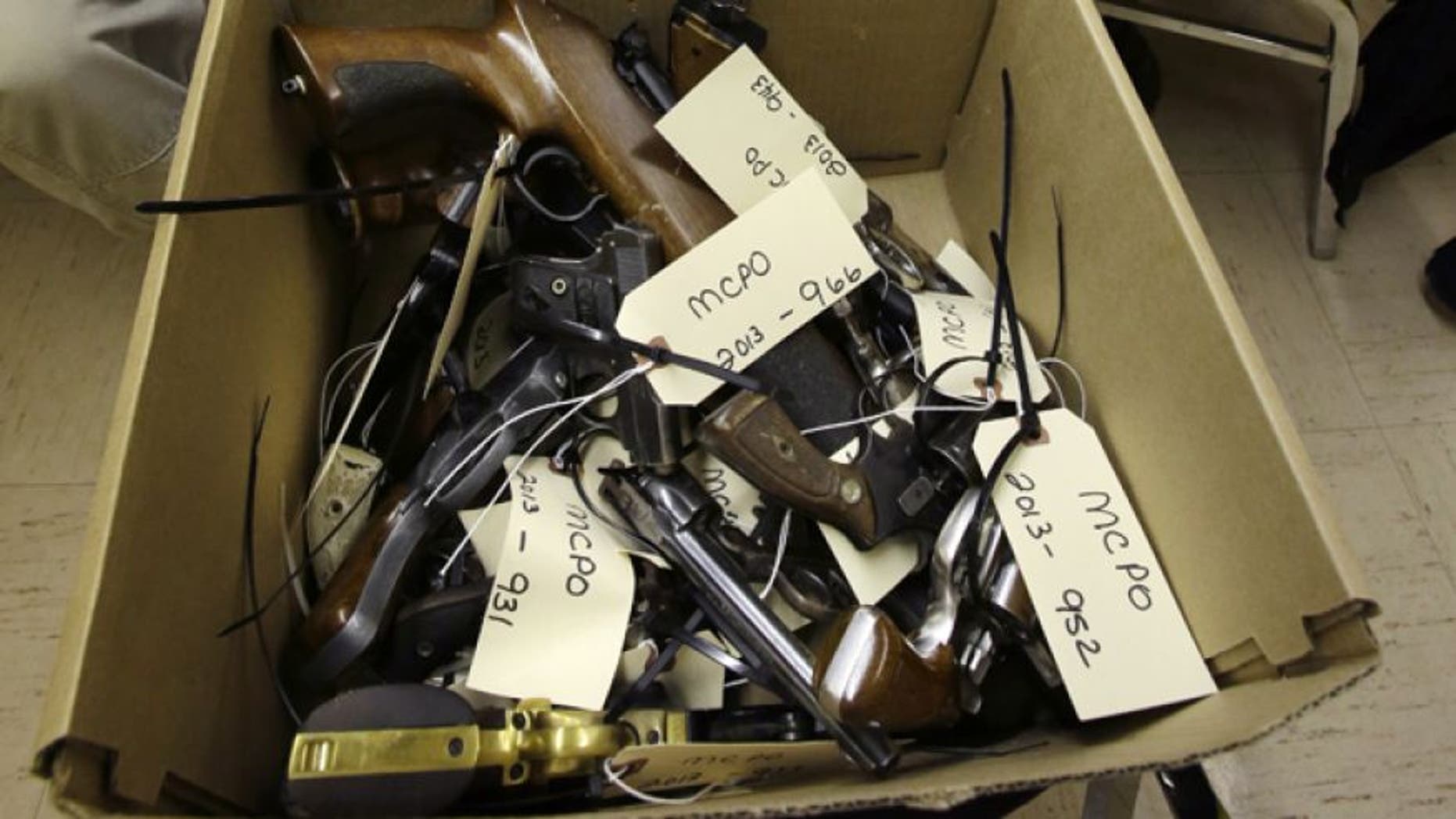 Jan. 26, 2013: Hand guns are seen in a box in Trenton, N.J., during a gun buyback event.