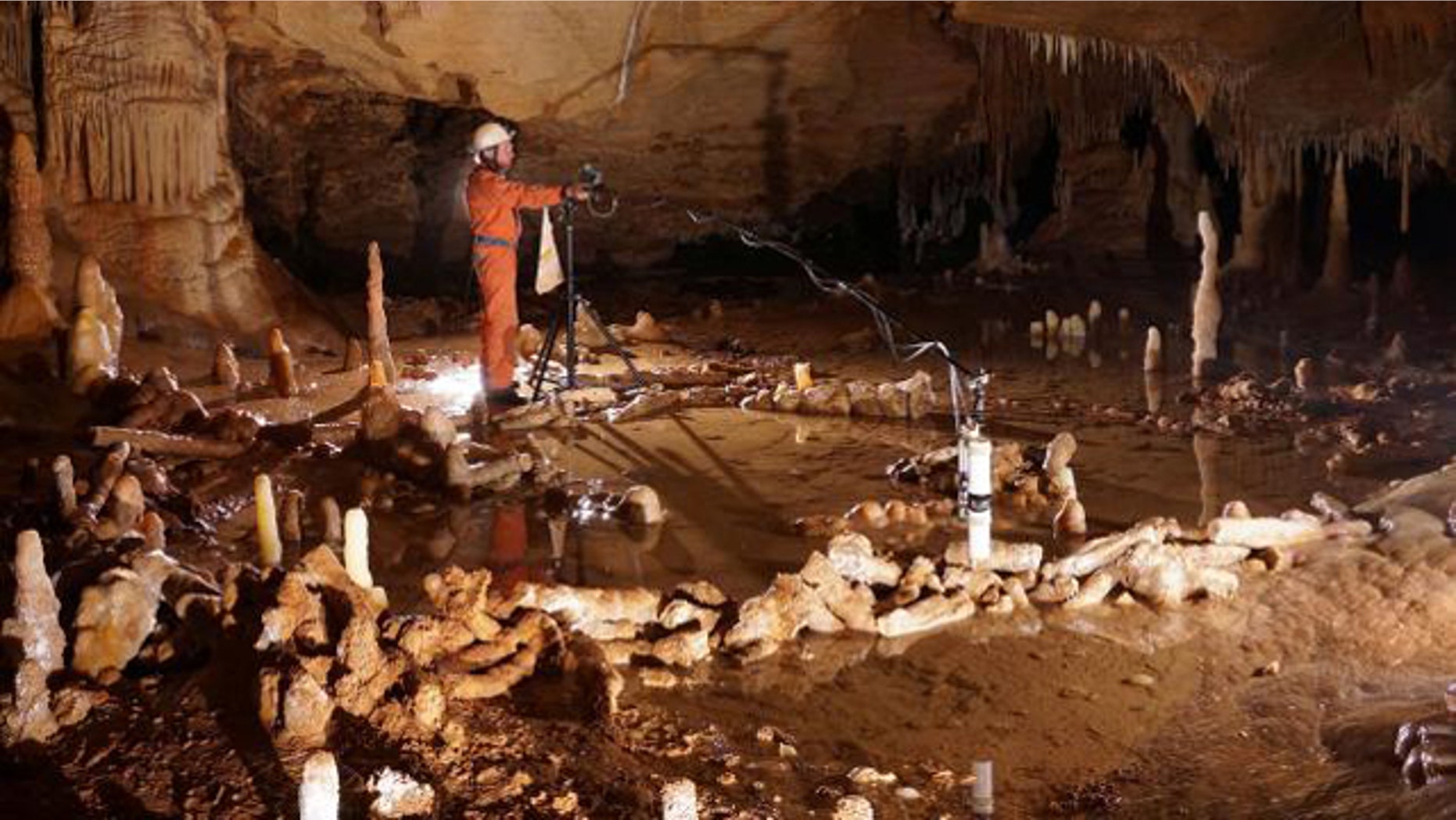 This undated photo shows scientist takes measurements for the archaeo-magnetic survey in the Bruniquel Cave in southwestern France after the discovery there of mysterious ring-shaped structures fashioned about 176,500 years ago by Neanderthals.