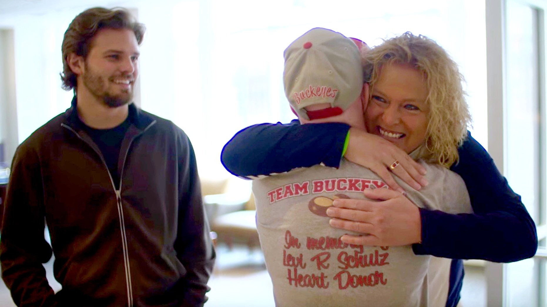 In this Friday, April 1, 2016 image made from video provided by Nebraska Medicine, Lisa Swanson meets Terry Hooper for the first time after the Nebraska man received her son's heart, in Omaha, Neb. Hooper received the heart on Dec. 10, 2012, three days after 18-year-old Levi Schulz of Horace, North Dakota, died in a car crash. Schulz's twin brother, Shelby Schulz is at left.(Dave Hynek/ Nebraska Medicine via AP)