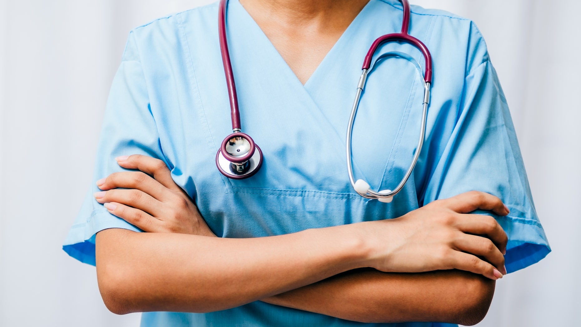 surgeon standing with arms fold across chest