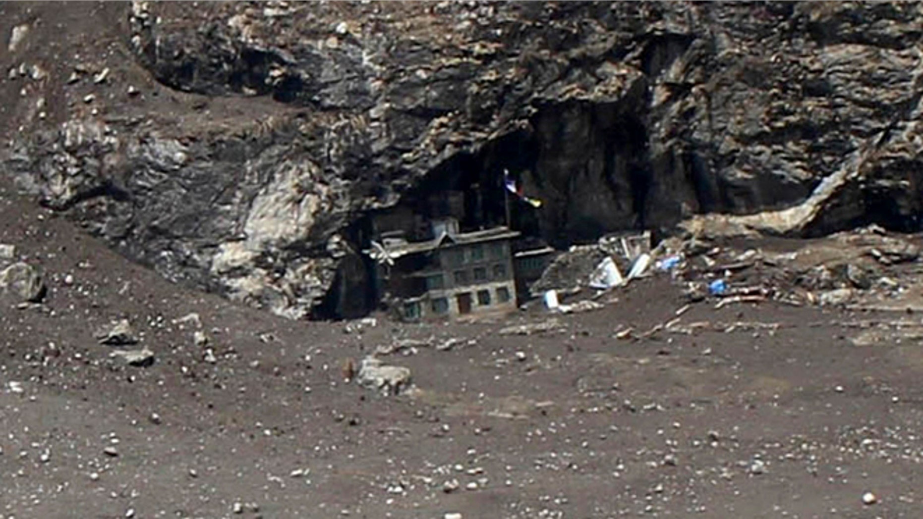 April 28, 2015: In this photo provided by Medecins Sans Frontieres, a lone house, center, is visible after a quake-triggered mudslide wiped out the village of Langtang, about 35 miles north of Kathmandu, Nepal.