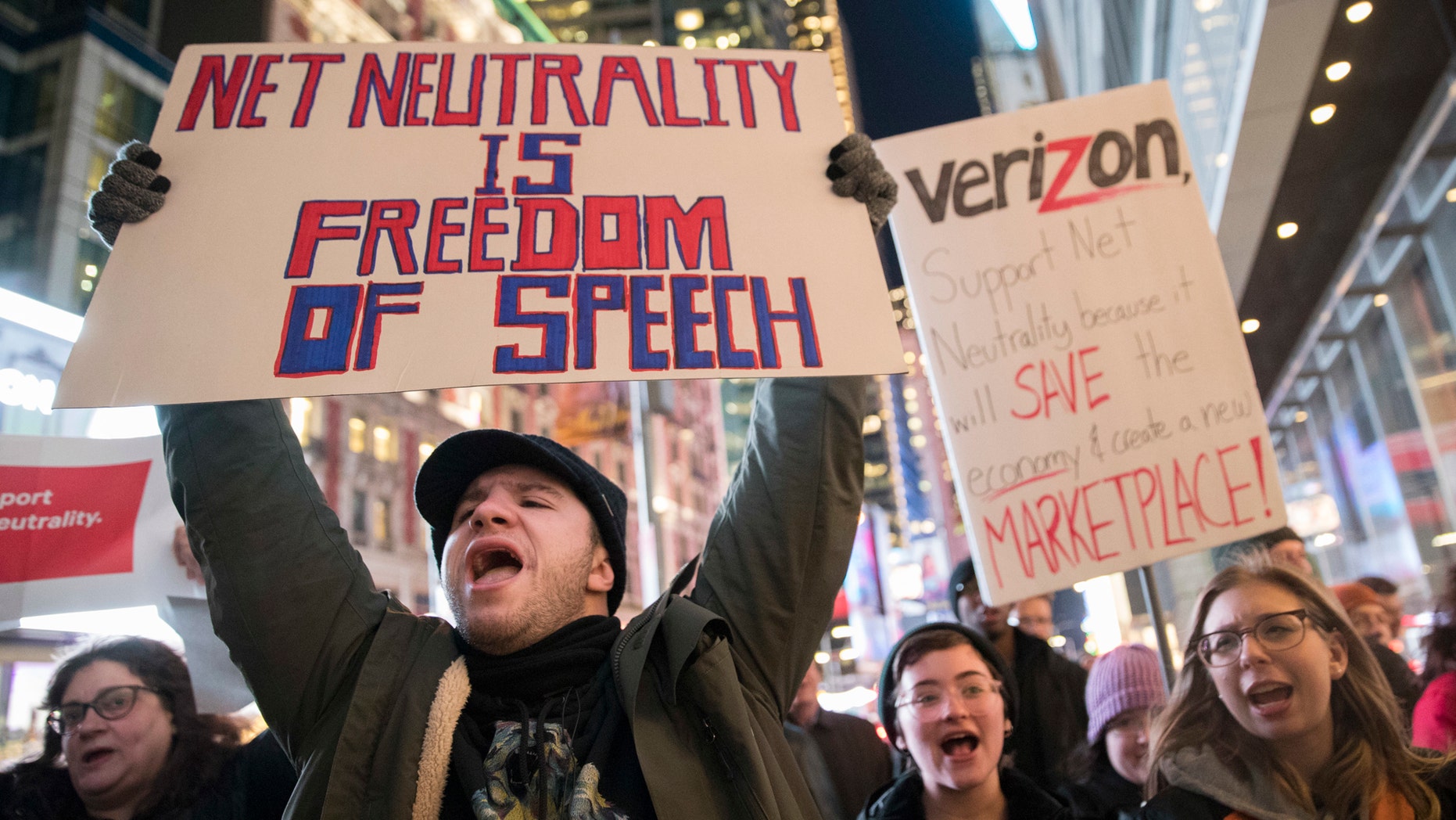 FILE - In this Thursday, Dec. 7, 2017 file photo, Demonstrators rally in support of net neutrality outside a Verizon store in New York. Consumers arenââ¬â¢t likely to see immediate changes following Monday, June 11, 2018 formal repeal of Obama-era internet rules that had ensured equal treatment for all. Rather, any changes are likely to happen slowly, and companies will try to make sure that consumers are on board with the moves, experts say. (AP Photo/Mary Altaffer, File)