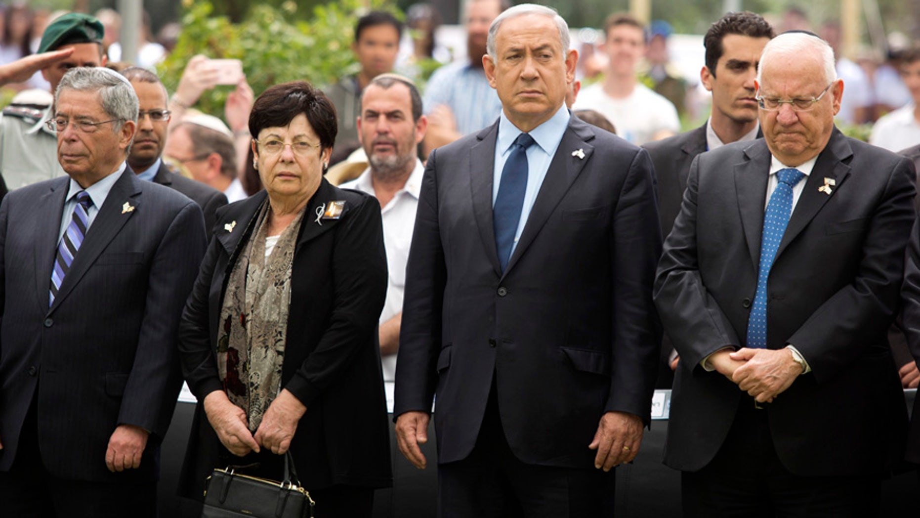 May 11, 2016: Israeli Prime Minister Benjamin Netanyahu (center) stands with President Reuven Rivlin during an official state Memorial Day service for the country’s fallen soldiers and victims of terrorism with a two minute siren during a ceremony held on Mount Herzl Cemetery.