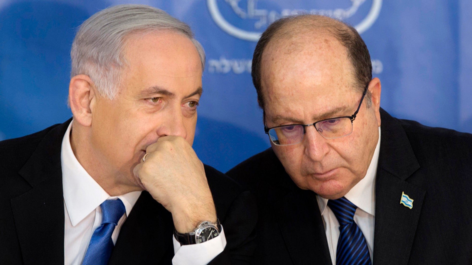 Feb. 16, 2015: Israeli Prime Minister Benjamin Netanyahu, left, speaks with Israel's Defense Minister Moshe Yaalon during a ceremony for new Israeli Chief of Staff Gadi Eizenkot at the Prime Minister's office in Jerusalem.