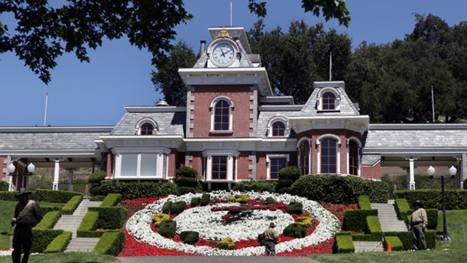 FILE - In this July 2, 2009, file photo, workers standby at the train station at Neverland Ranch in Los Olivos, Calif. Michael Jackson's former home has been renamed Sycamore Valley Ranch. The Los Angeles Times reported March 1, 2017, that it had been relisted for sale for $67 million. (AP Photo/Carolyn Kaster, File)