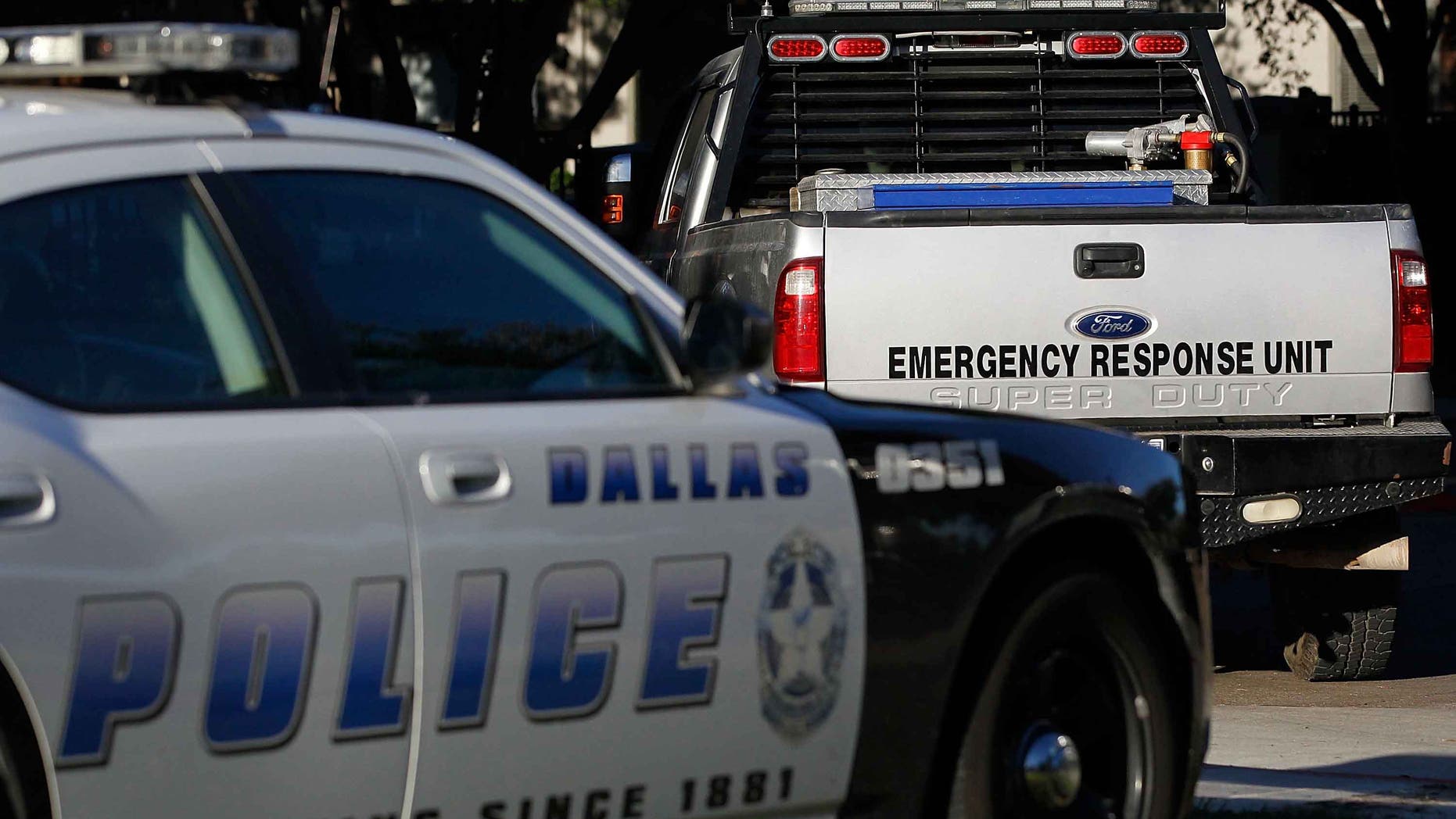 DALLAS, TX - OCTOBER 16: A Dallas police car and an emergency response vehicle sit in the parking lot at the The Village Bend East apartment complex where a second health care worker who has tested positive for the Ebola virus resides on October 16, 2014 in Dallas, Texas. Nurse Amber Vinson joins Nina Pham as health workers who have contracted the Ebola virus at Texas Heath Presbyterian Hospital while treating patient Thomas Eric Duncan, who has since died. (Photo by Mike Stone/Getty Images)