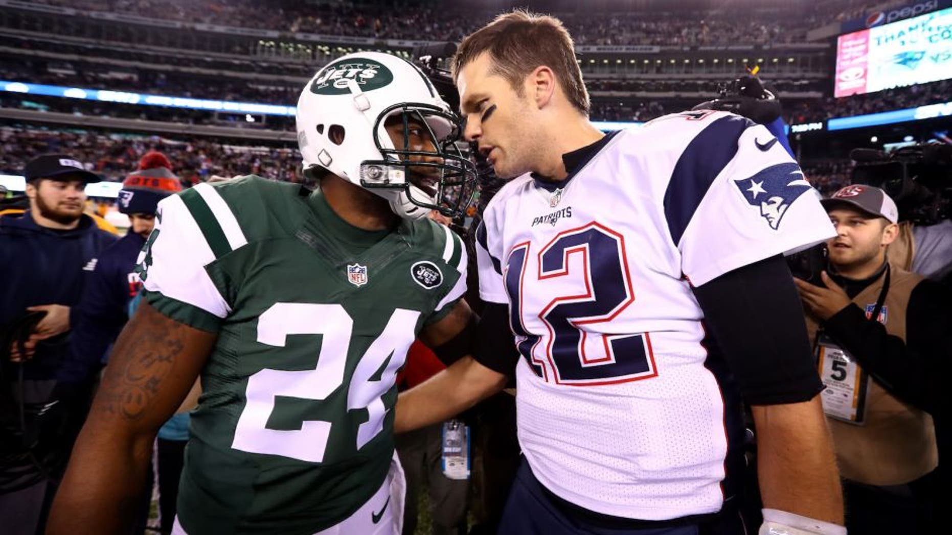 EAST RUTHERFORD, NJ - NOVEMBER 27: (L-R) Darrelle Revis #24 of the New York Jets talks with Tom Brady #12 of the New England Patriots after their game at MetLife Stadium on November 27, 2016 in East Rutherford, New Jersey. The New England Patriots defeated the New York Jets with a score of 22 to 17. (Photo by Al Bello/Getty Images)