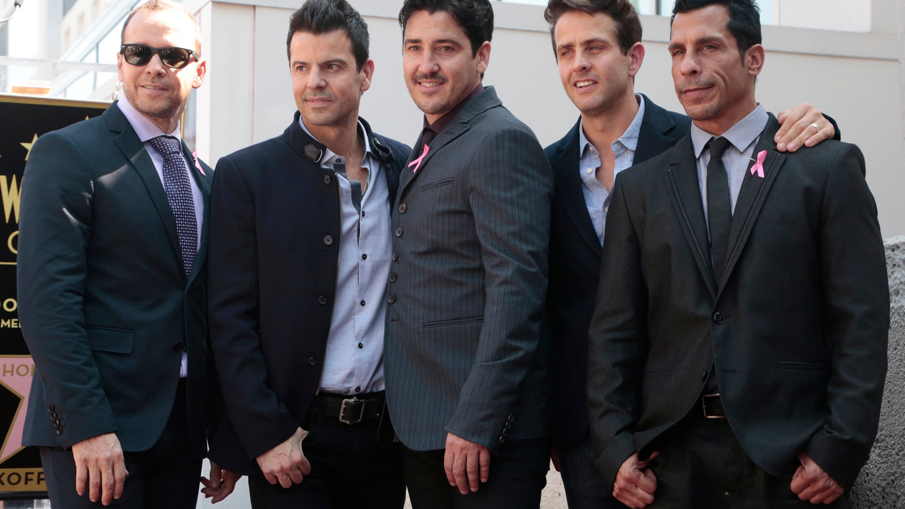 October 9, 2014. New Kids On The Block band members (L-R) Donnie Wahlberg, Jordan Knight, Jonathan Knight, Joey McIntyre and Danny Wood pose on their star after it was unveiled on the Walk of Fame in Hollywood.