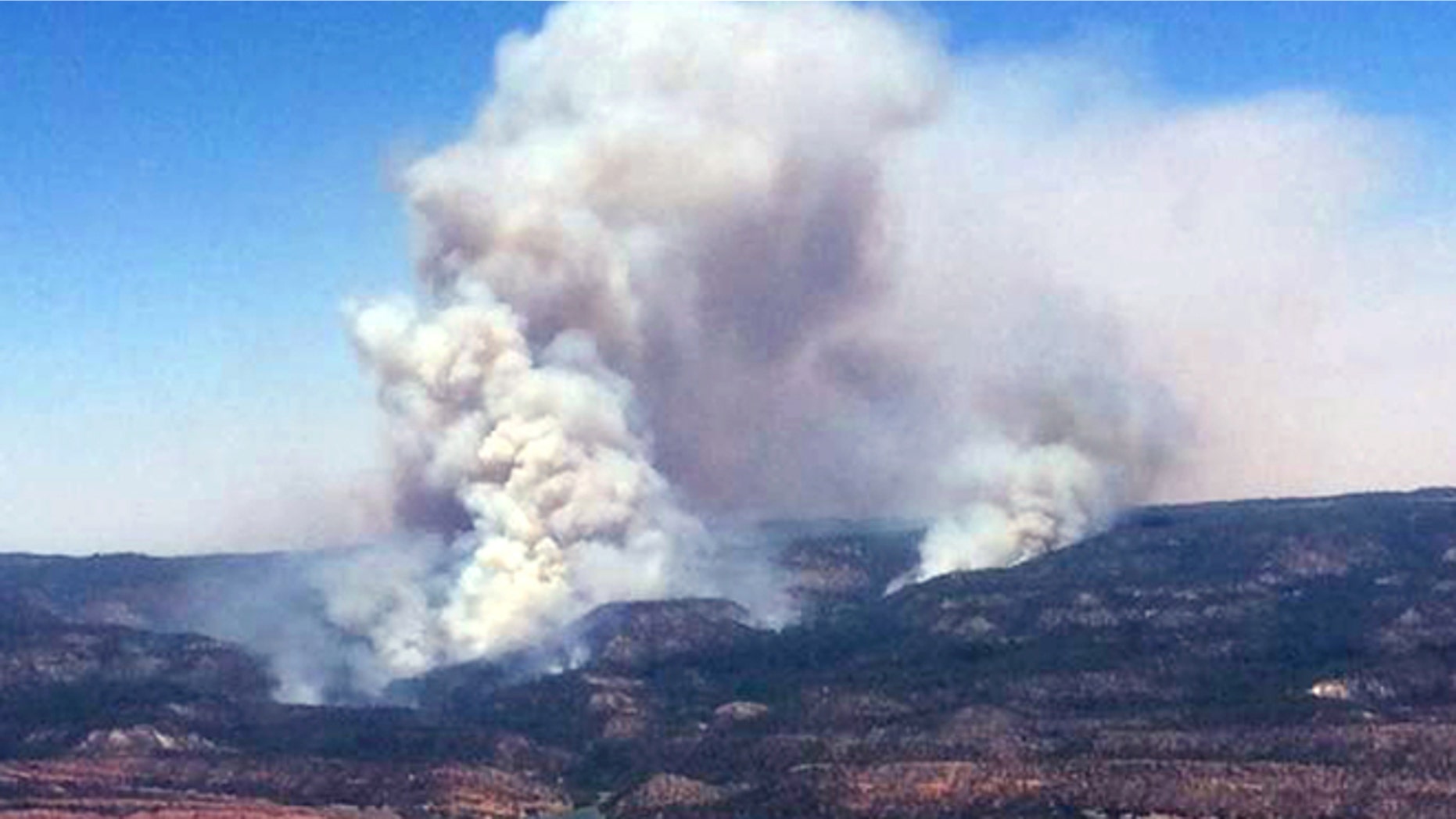 June 15, 2014: This image provided by Inci Web shows a plume of smoke in the Chuska Mountains near Naschitti, N.M.