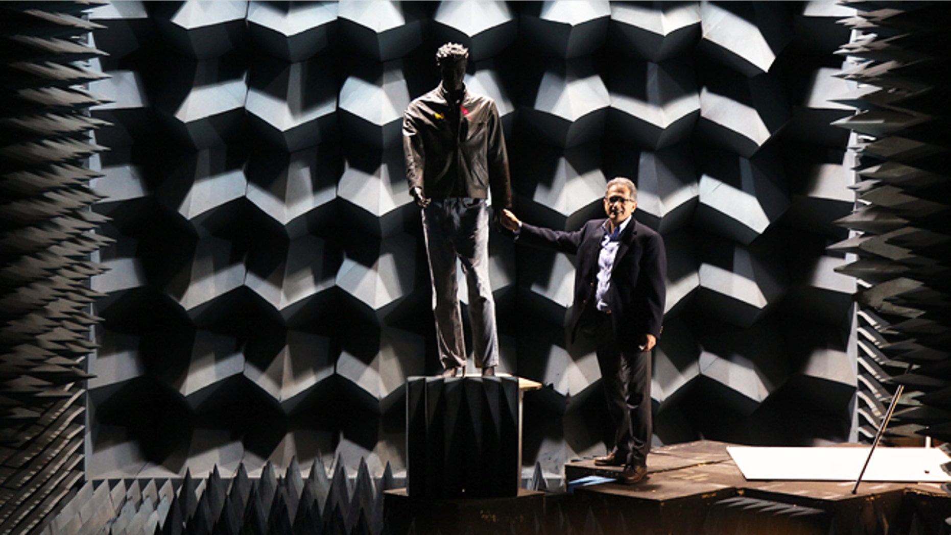 Professor Kamal Sarabandi approaches a mannequin he uses to test the radar in the anechoic chamber.In the aftermath of the Newtown school shooting, a University of Michigan, College of Engineering professor Kamal Sarabandienvisions a new use for a weapons-detecting radar system heâs been developing for thepast few years. The technology could potentially identify a hidden gun or bomb on anapproaching person from the distance of a football field away in less than a second.